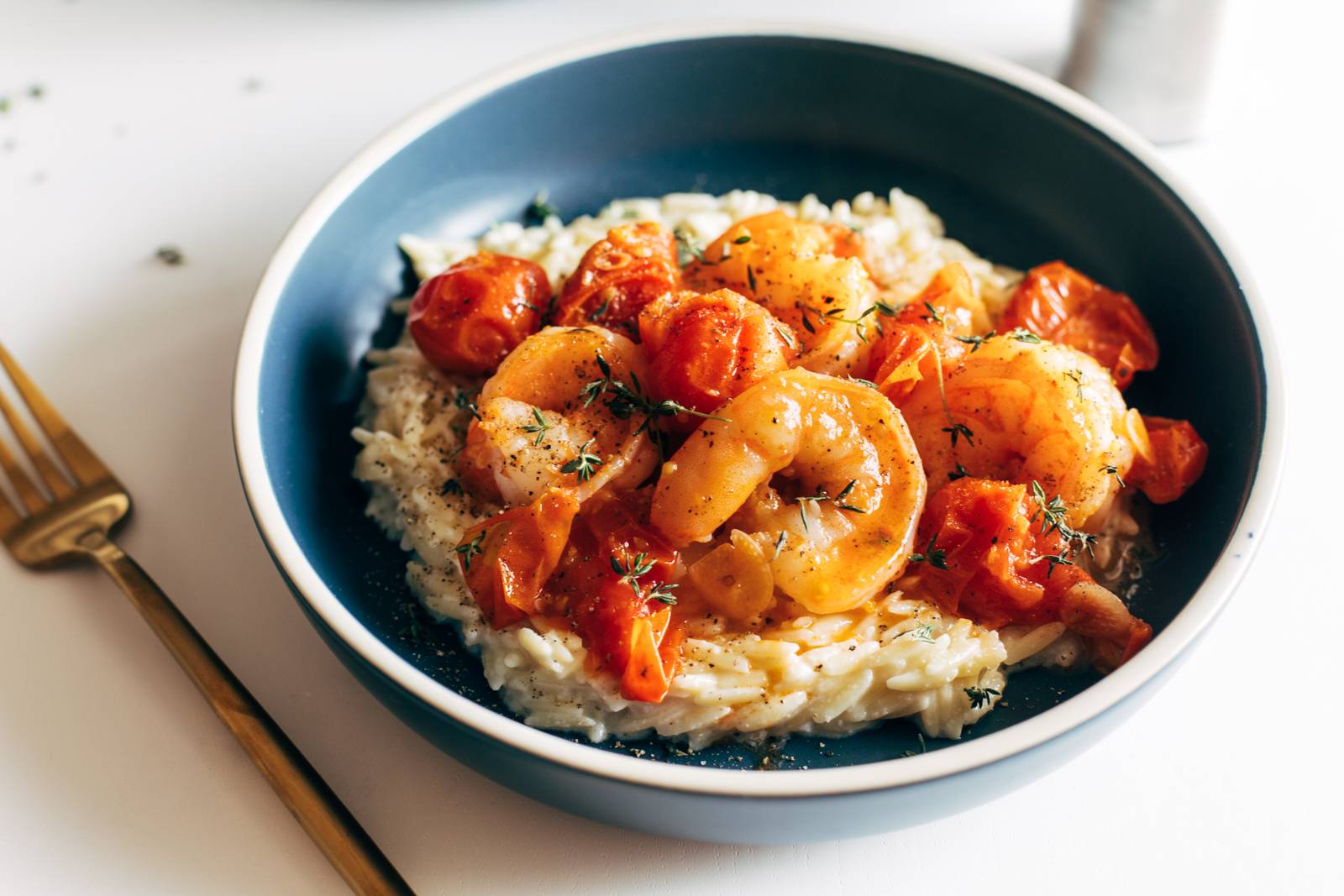 Ozro, shrimp, and tomatoes in blue bowl