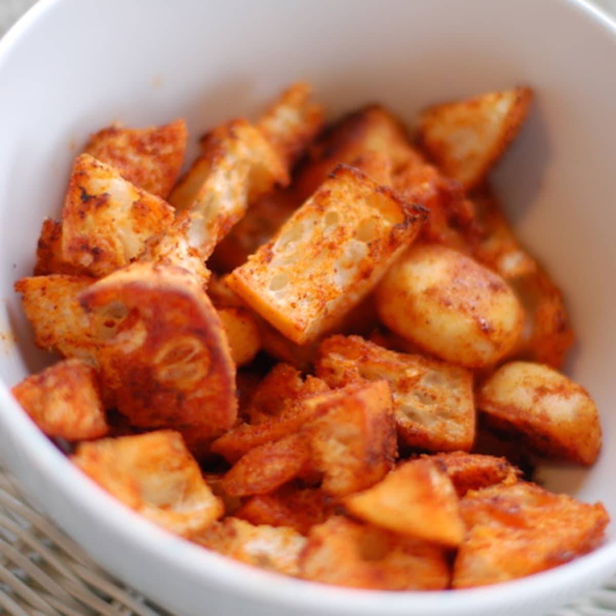 Smoky paprika croutons in a white bowl.