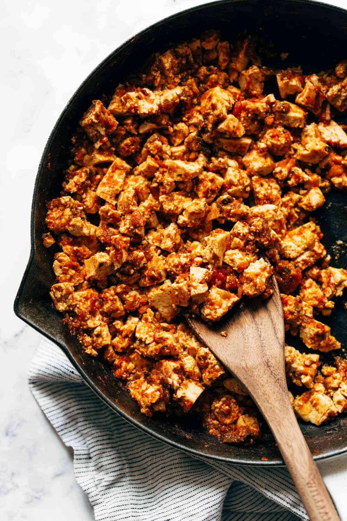 Sofritas in a skillet with a wooden spoon