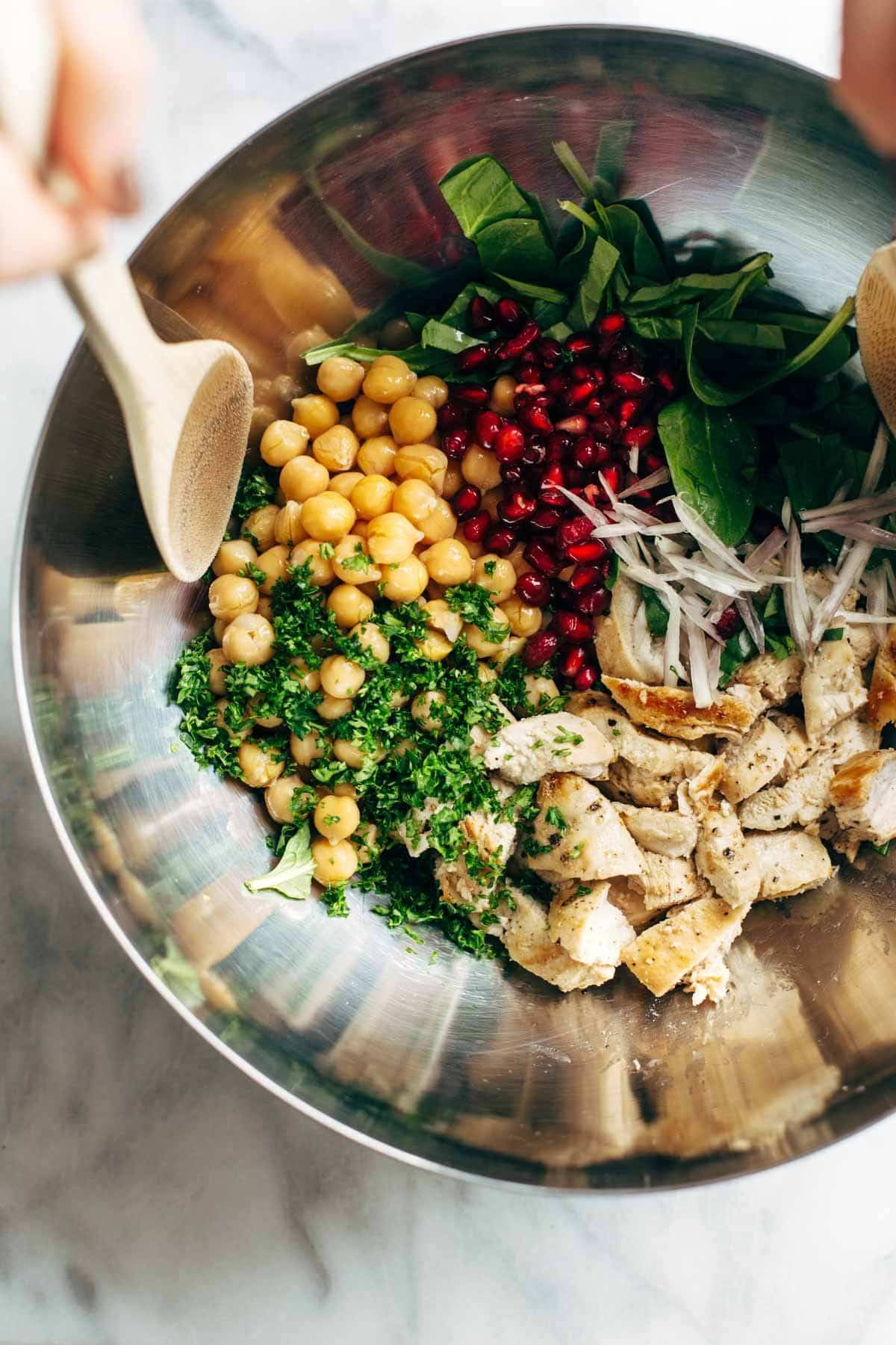 Winter Spa Salad with Lemon Chicken! Loaded with chickpeas, spinach, pomegranates, Cara Cara oranges, avocado, shallots, herbs, dressing, and lemon chicken. | pinchofyum.com