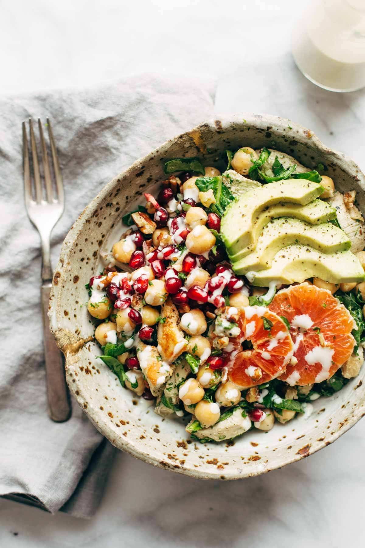 Winter Spa Salad with Lemon Chicken! Loaded with chickpeas, spinach, pomegranates, Cara Cara oranges, avocado, shallots, herbs, dressing, and lemon chicken. | pinchofyum.com