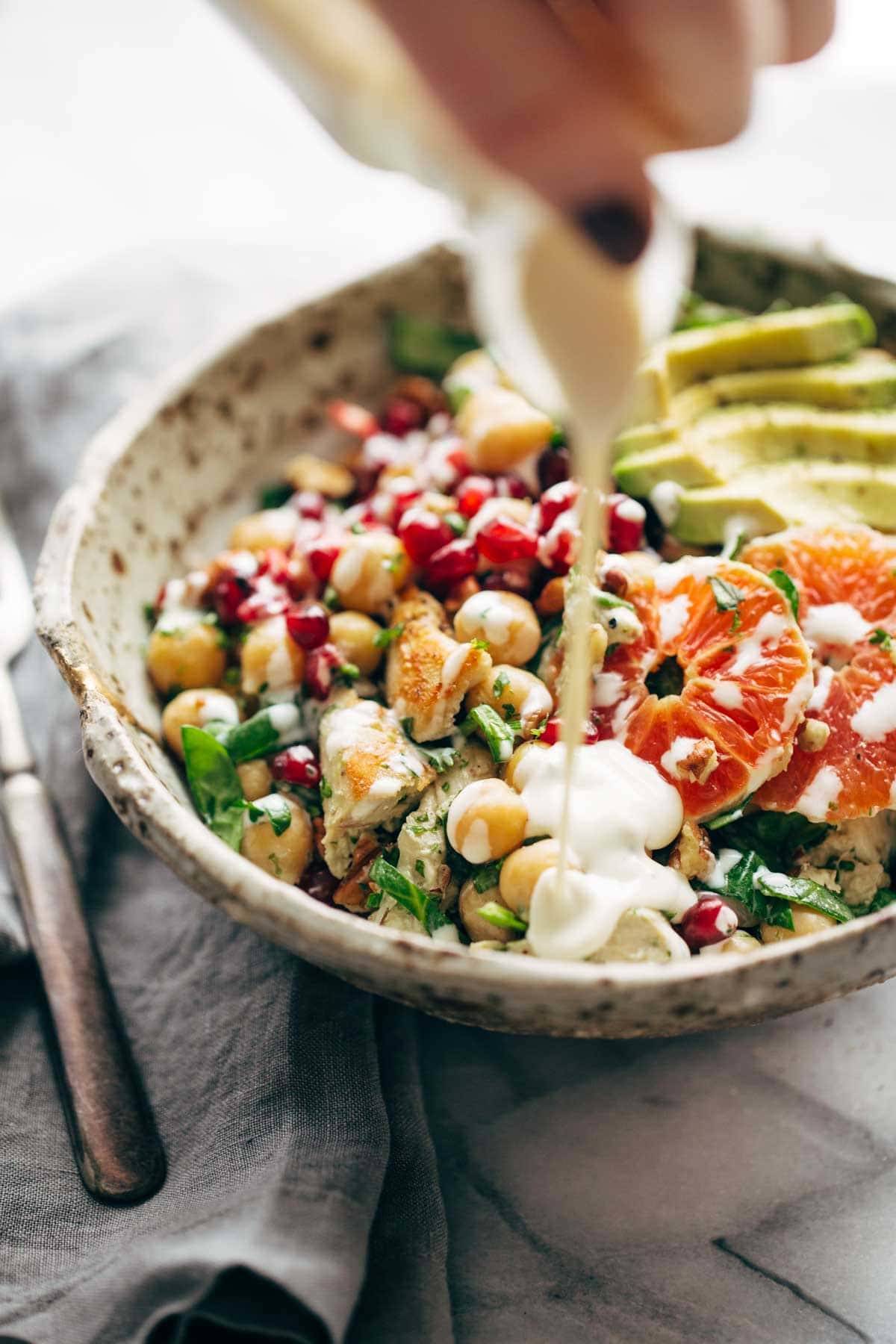 Winter Spa Salad with Lemon Chicken! Loaded with chickpeas, spinach, pomegranates, Cara Cara oranges, avocado, shallots, herbs, dressing, and lemon chicken. | pinchofyum.com
