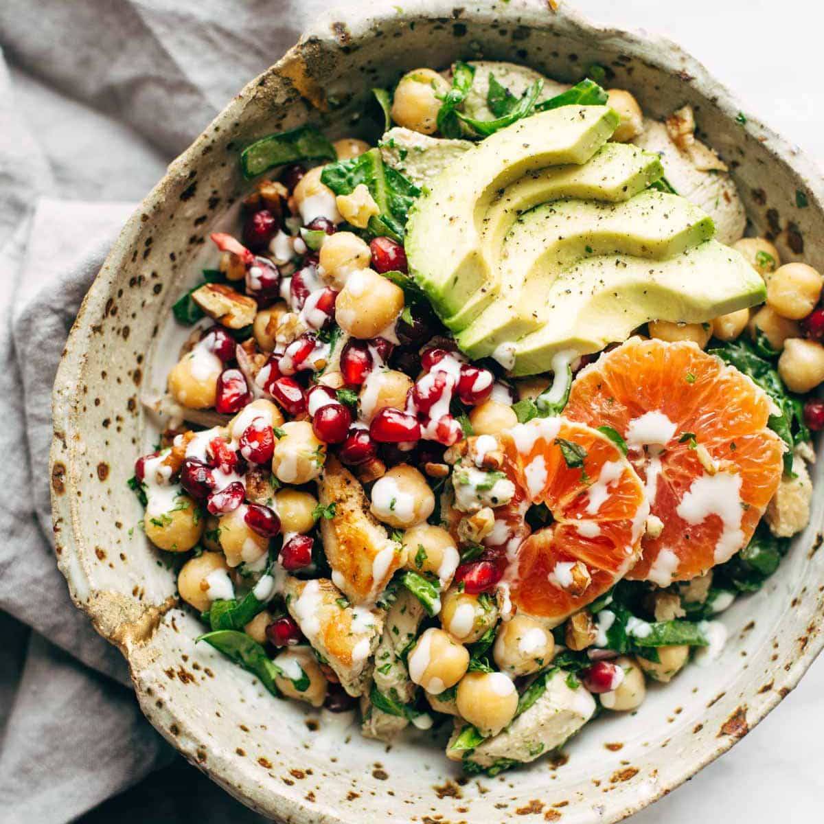 Winter Spa salad in a bowl with chickpeas, avocado, and oranges.