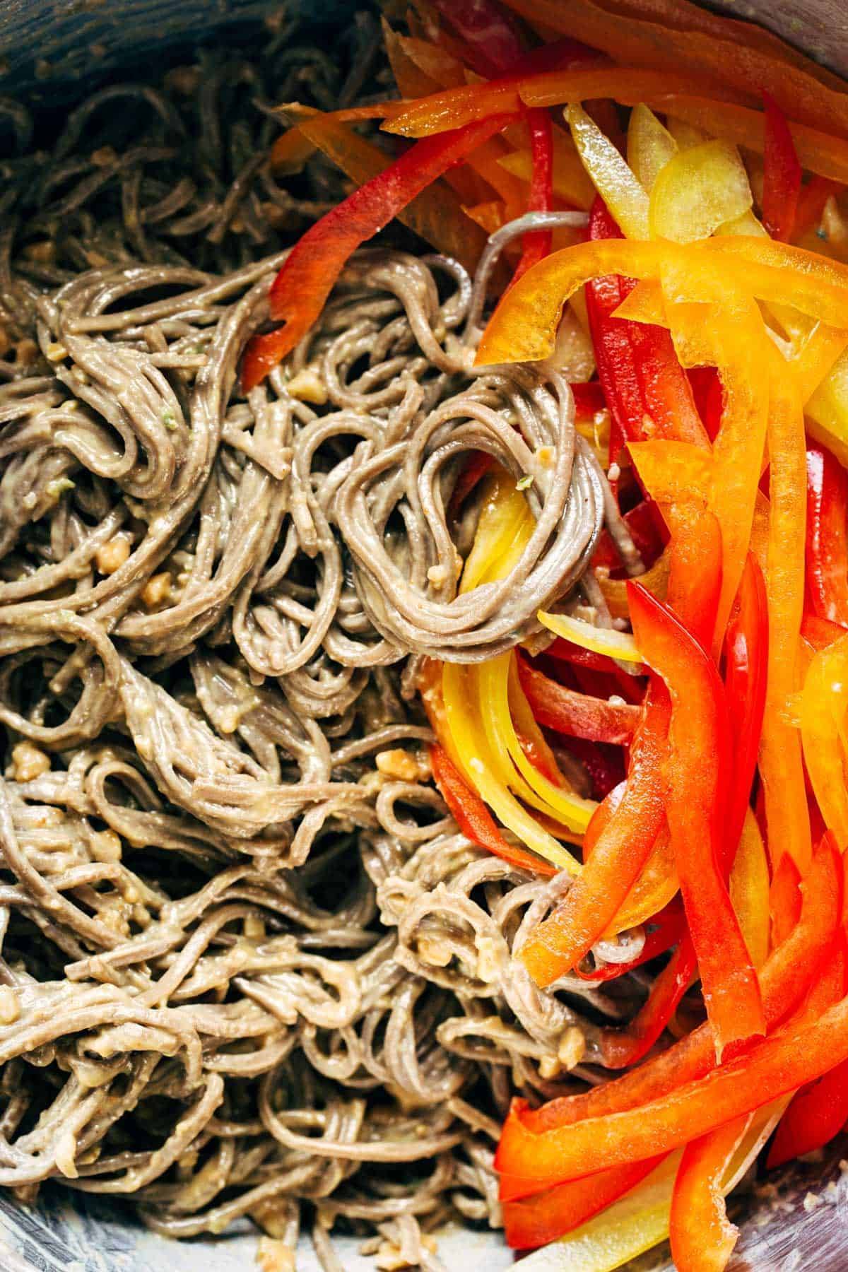 Close-up of soba noodles and bell peppers.