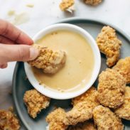 Baked Popcorn Chicken dipped in a sauce.