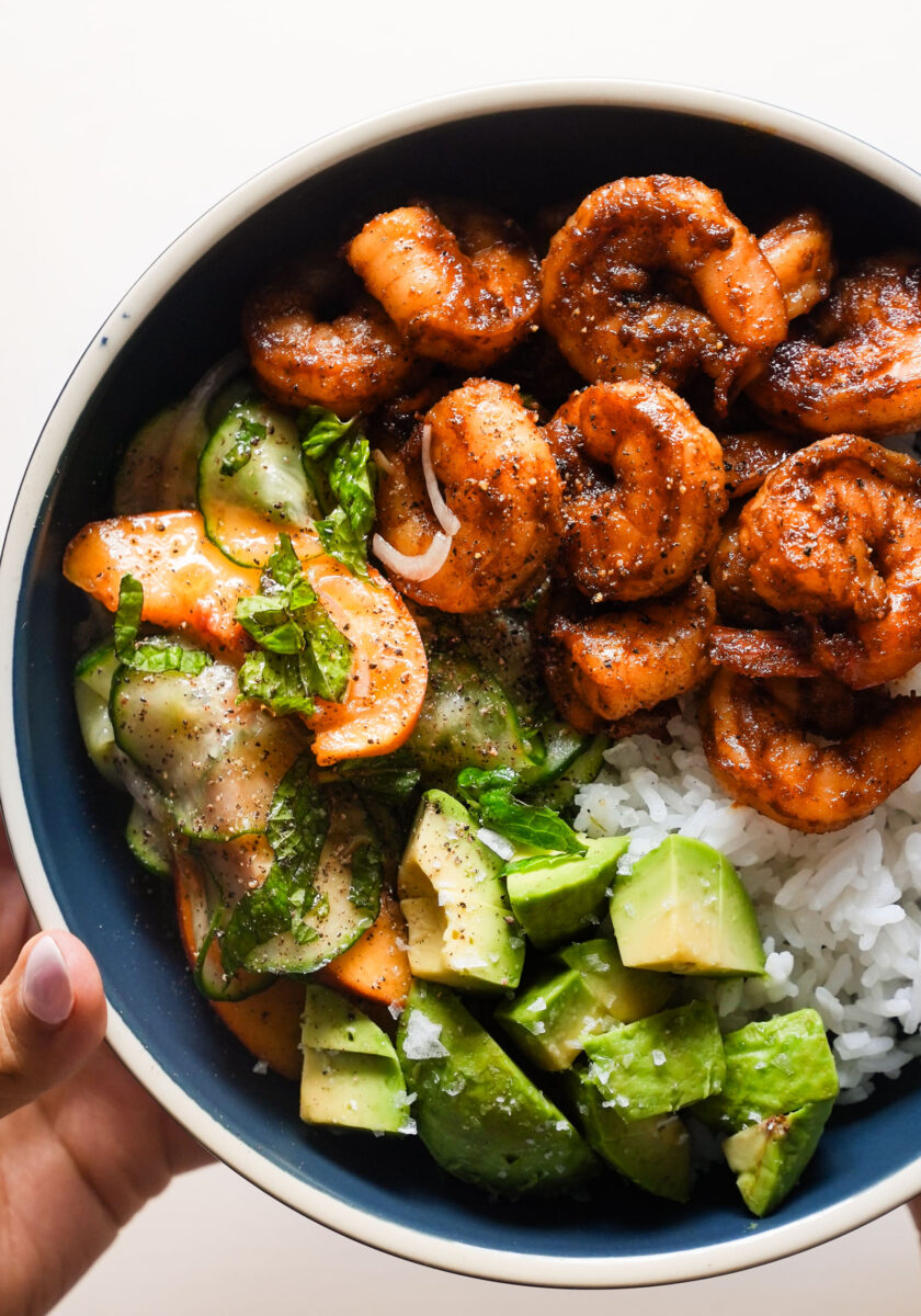Spicy shrimp in a bowl with rice and peach salad.