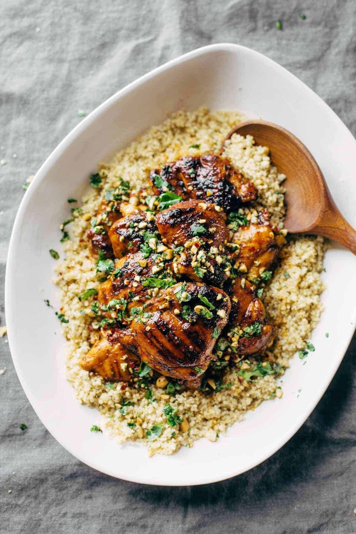 chicken with quinoa in a bowl with a wooden spoon