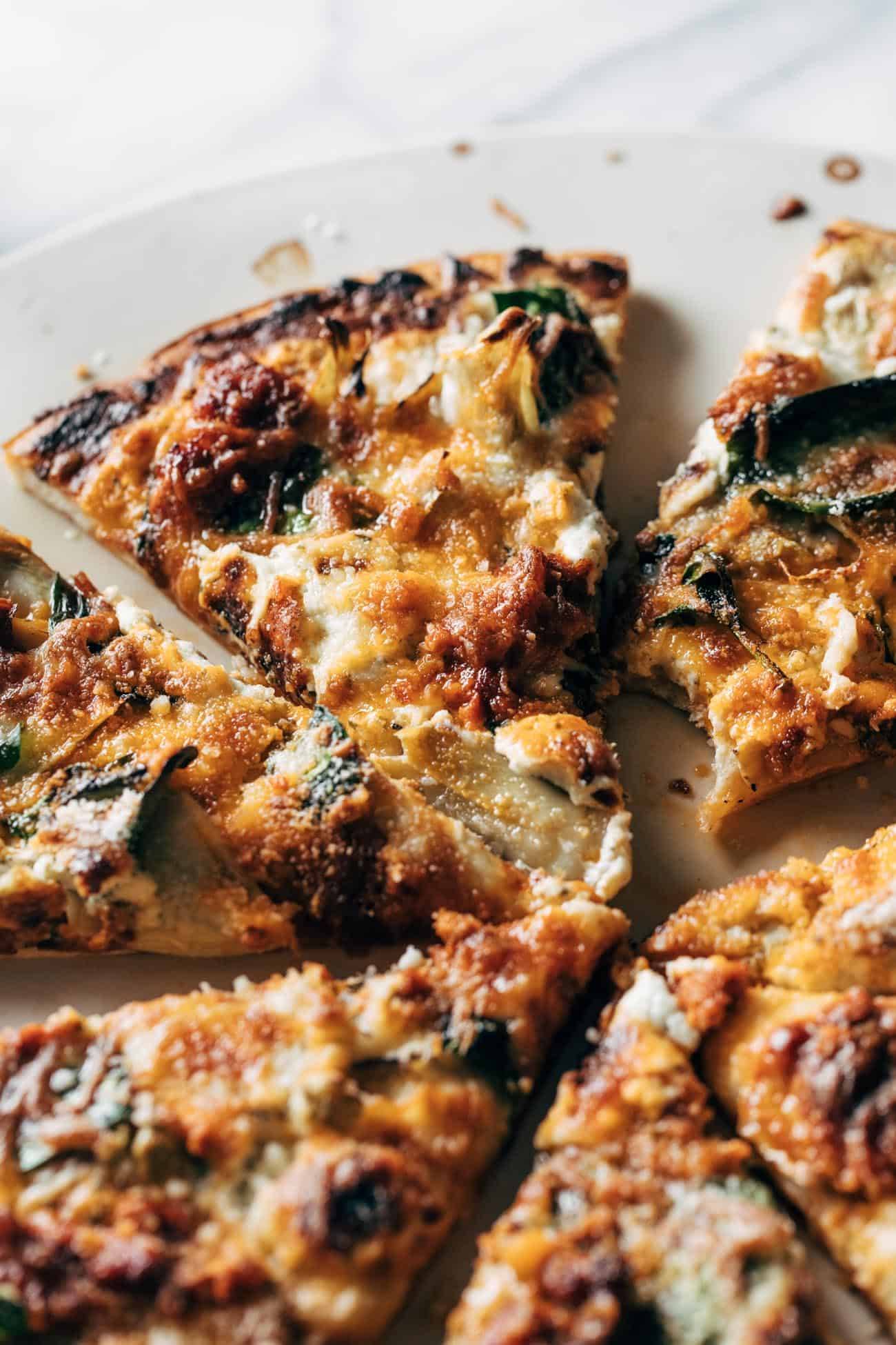 Spinach and artichoke pizza slices