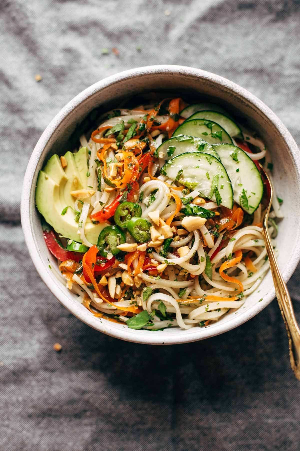 Spring roll bowl with noodles, cucumbers, avocados, and pepper.