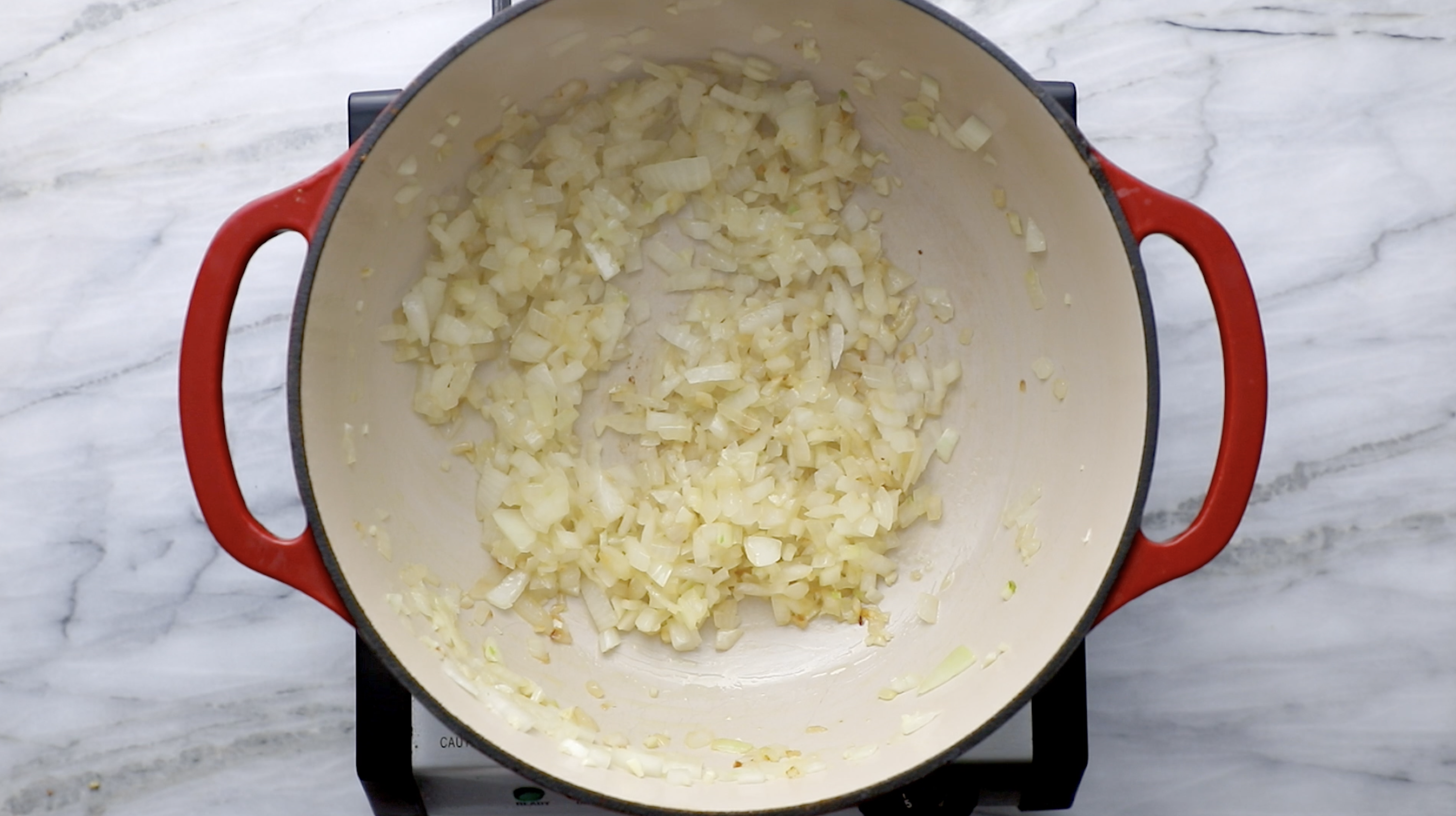 Onion and garlic in a dutch oven.