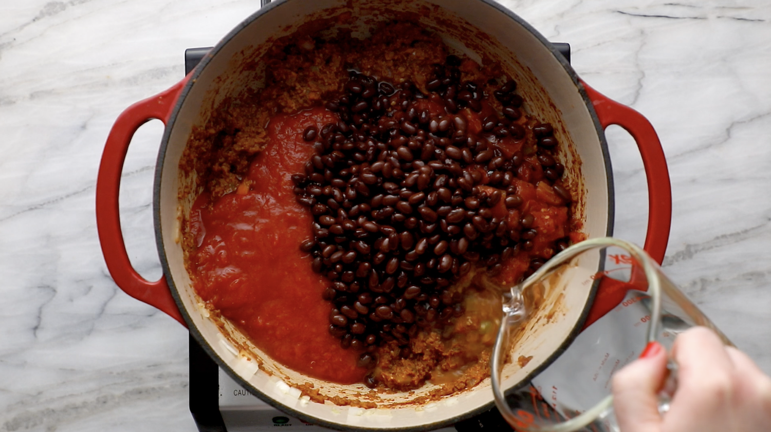 Tomatoes and Beans in a pot of chili.