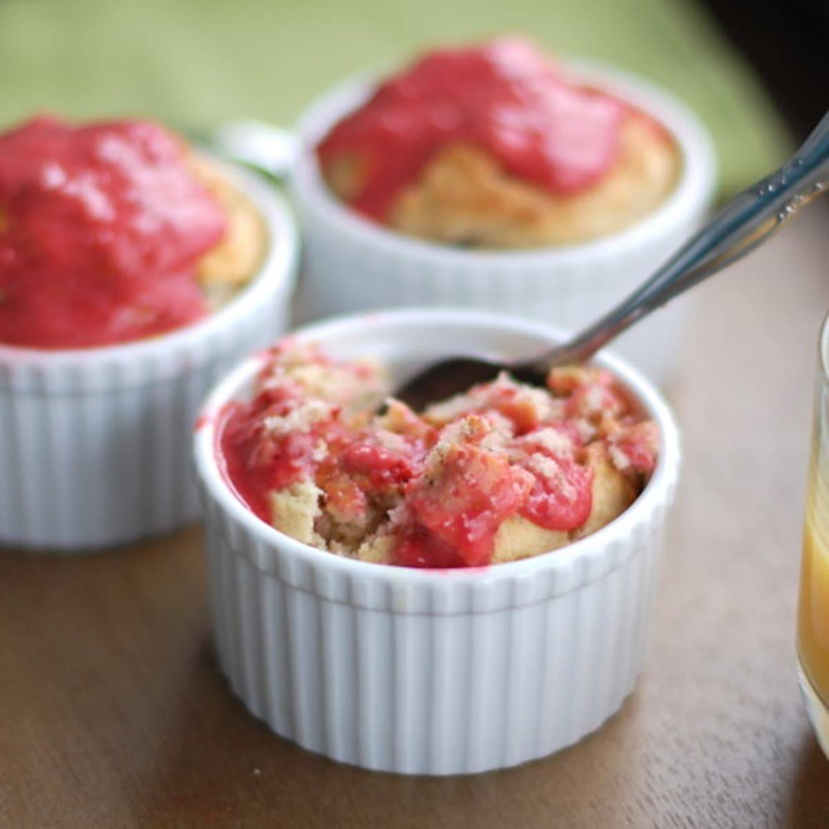 Strawberry breakfast cakes with strawberry sauce on top.