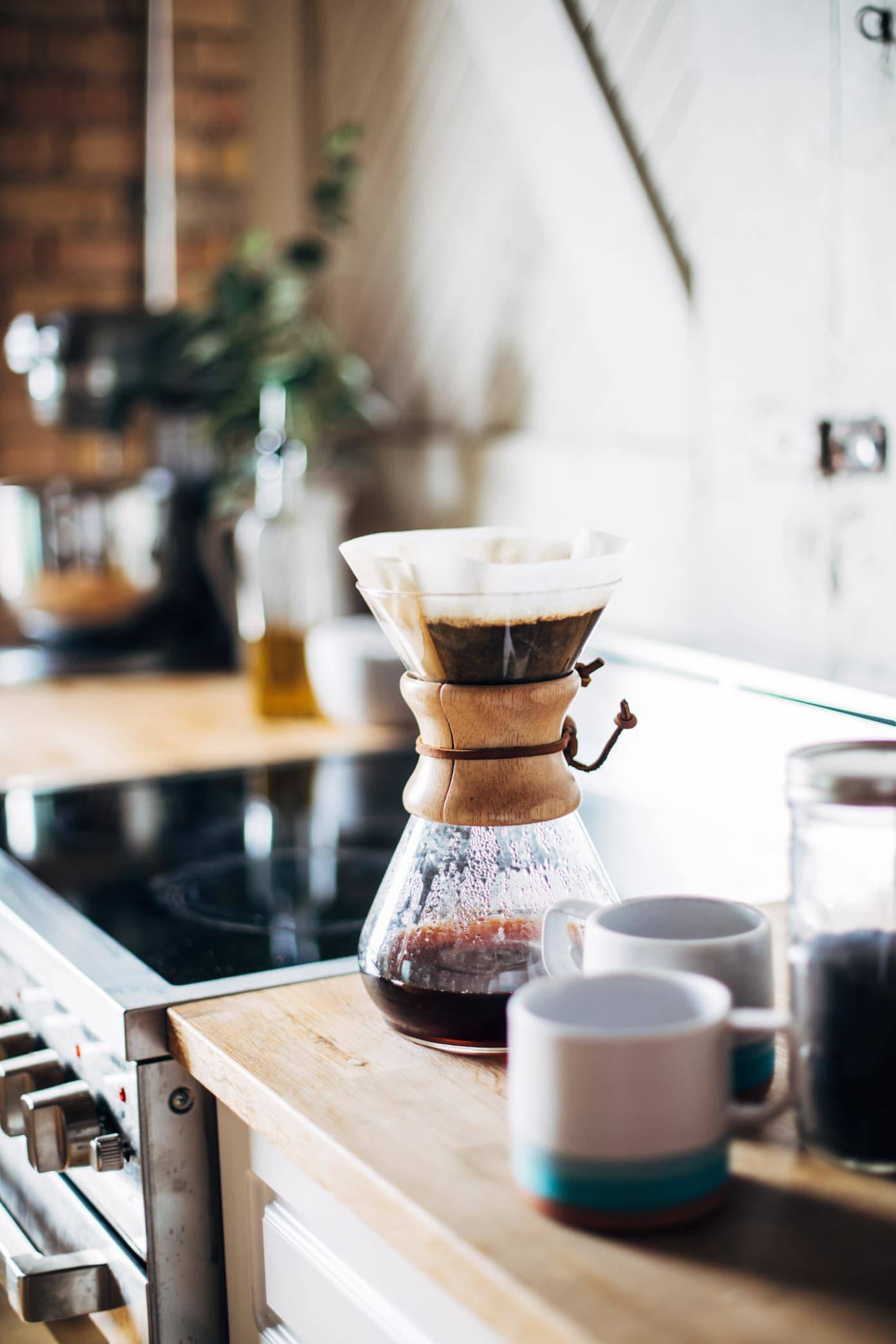 Chemex coffee maker on a counter.