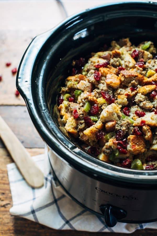 Slow cooker filled with pear and sausage stuffing.