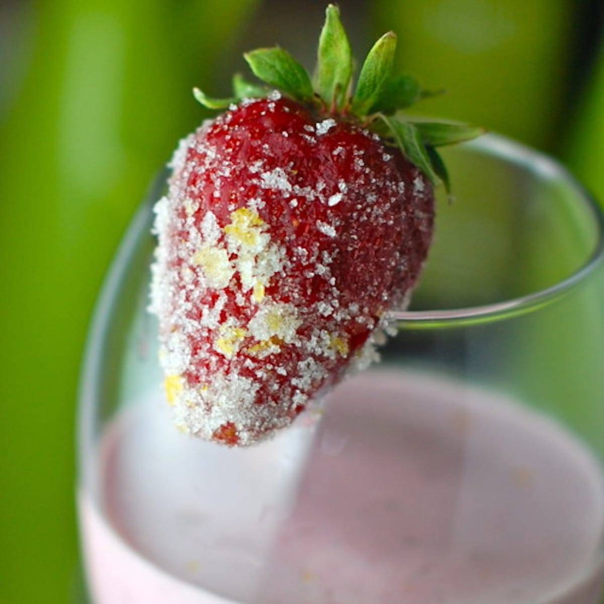 Lemon berry smoothie with sugar covered strawberry.