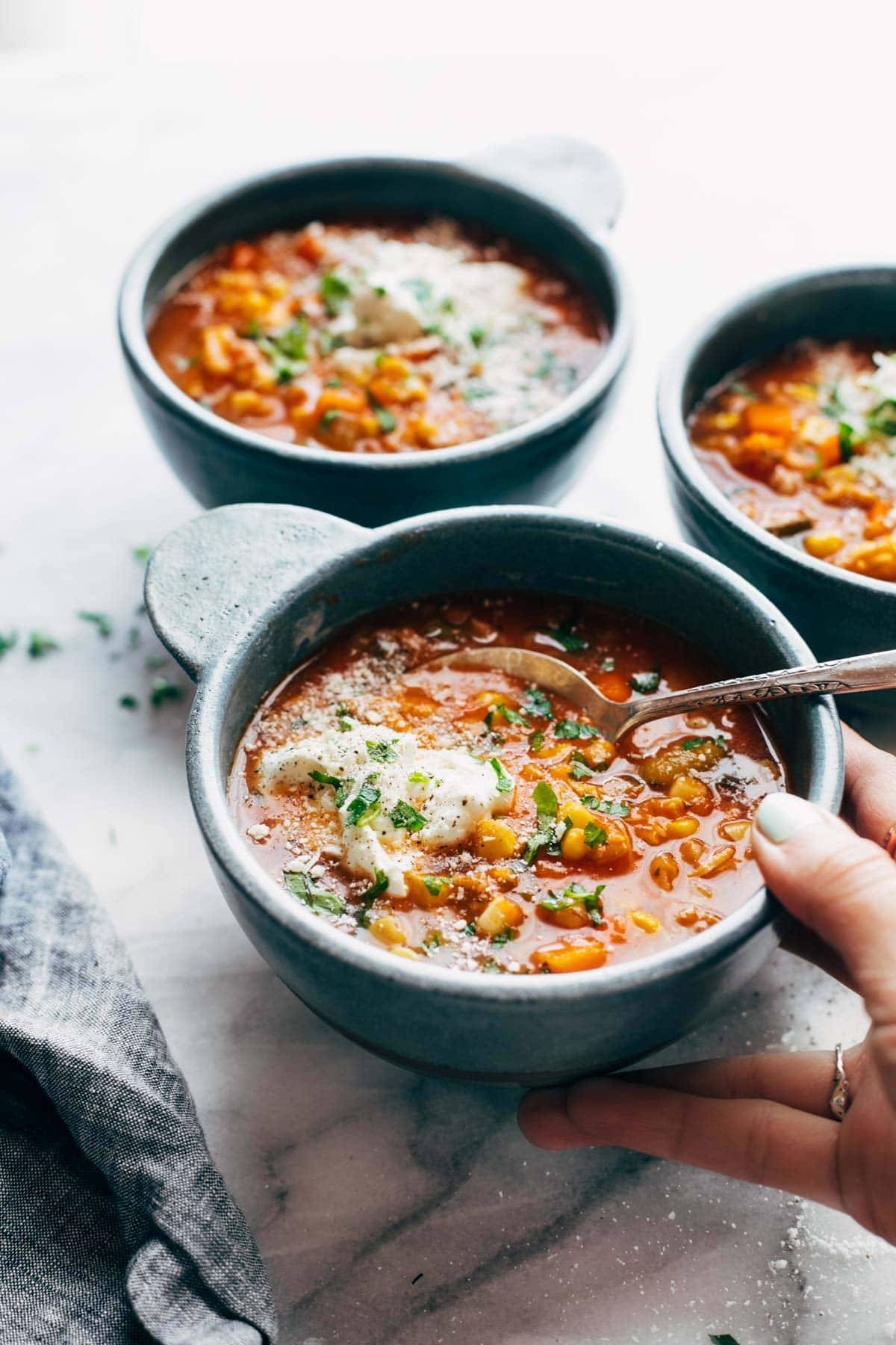 Instant Pot Summer Soup in a bowl held by a hand.