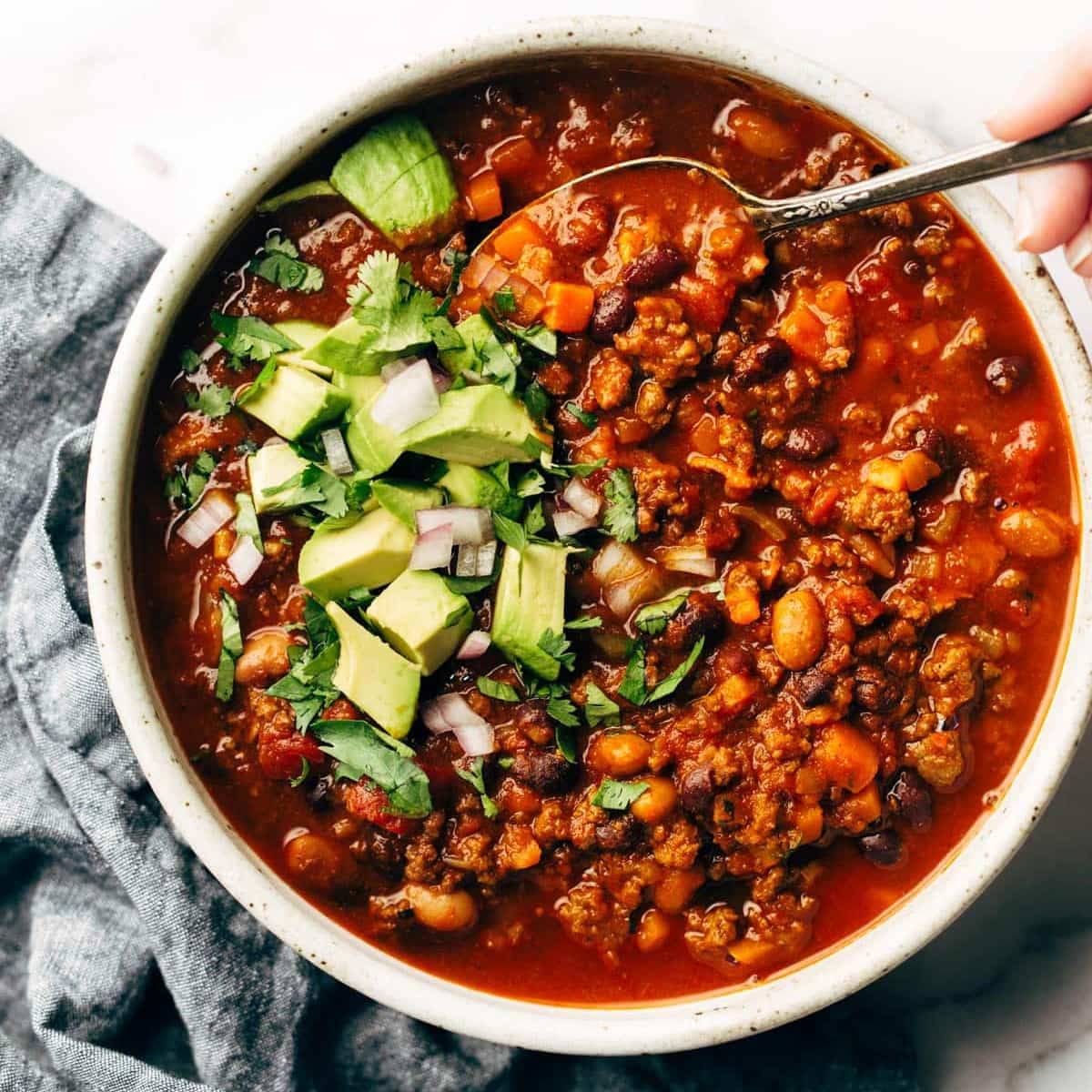 Sunday chili in a bowl with a spoon.