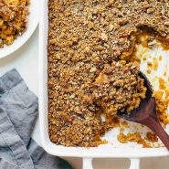 Sweet Potato Casserole on pan with serving spoon.