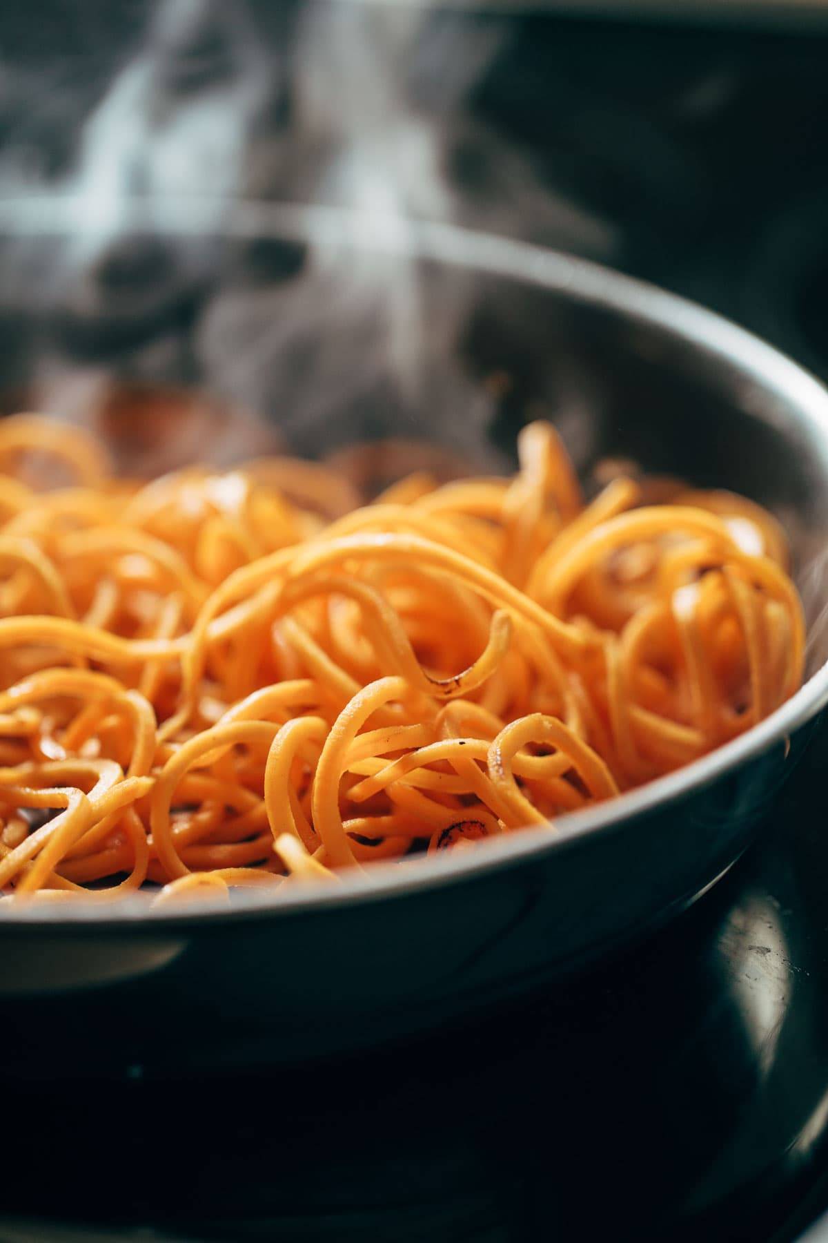 Sweet Potato Noodles steaming in a pan.