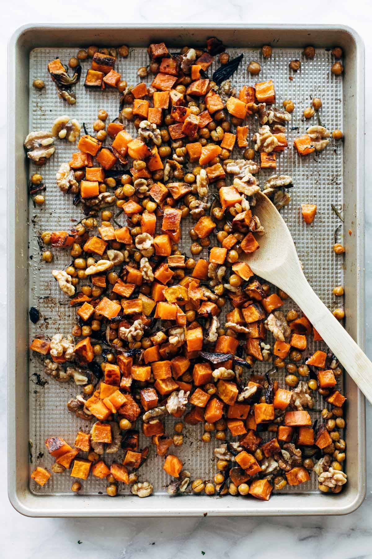Sweet potatoes, walnuts, and chickpeas on a sheet pan.