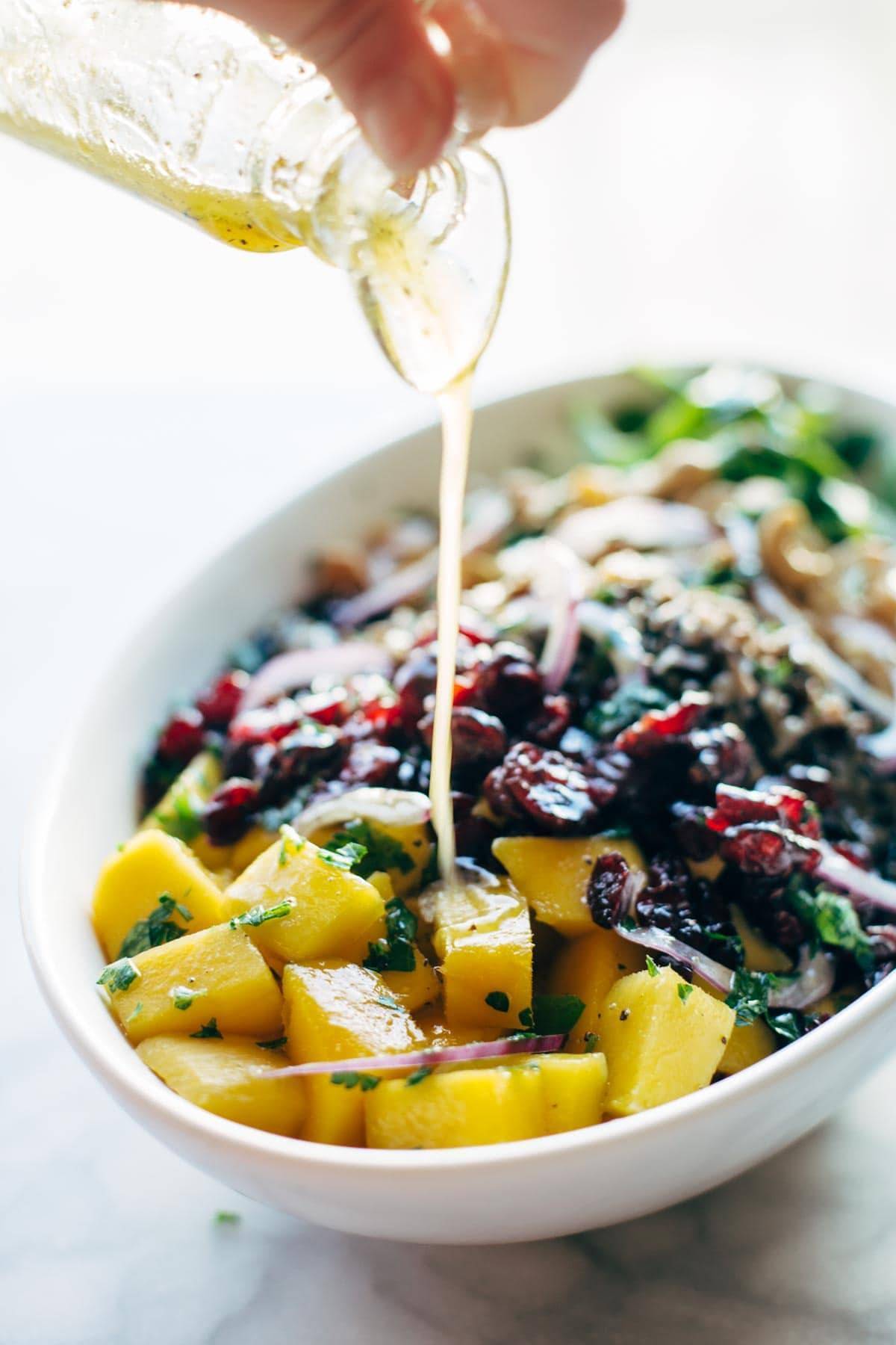 Easy Thanksgiving Salad - arugula, wild rice, cashews, dried cranberries, red onions, and a lemon dressing that shakes up easily in a jar. | pinchofyum.com