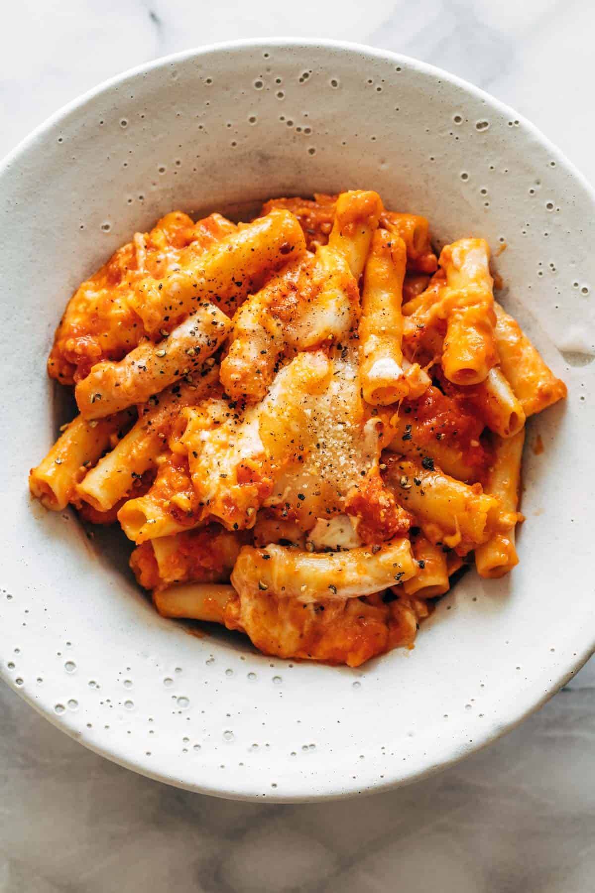 Baked ziti in a bowl with pepper.