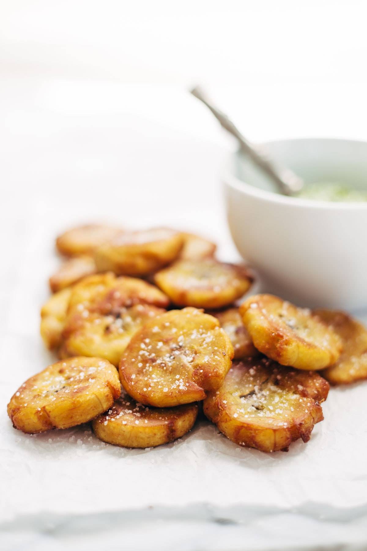Crispy Salted Tostones - super easy recipe for golden brown bites of perfection with just one ingredient: PLANTAINS! video demo in the post. | pinchofyum.com