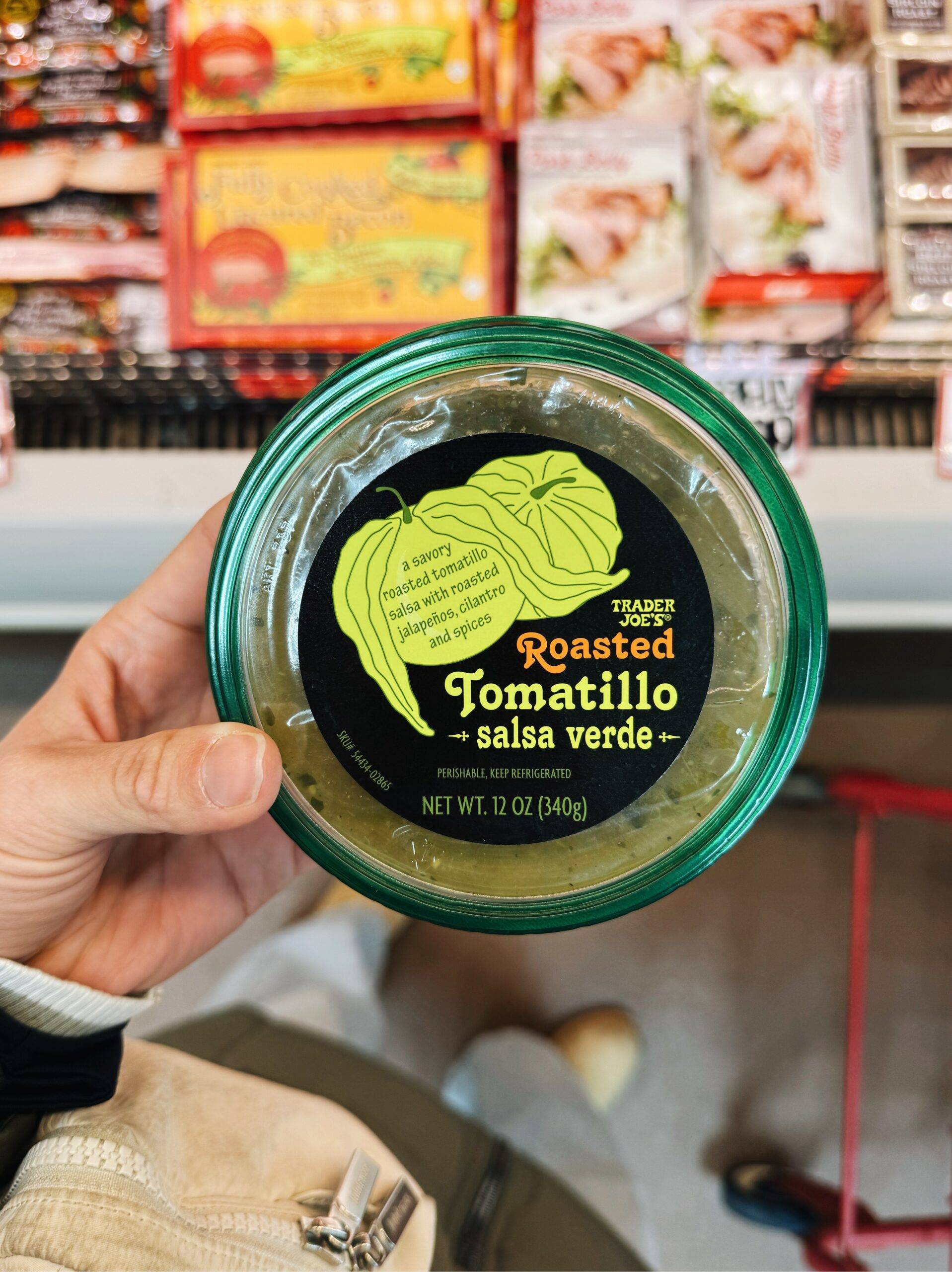 Container of roasted tomatillo salsa verde.