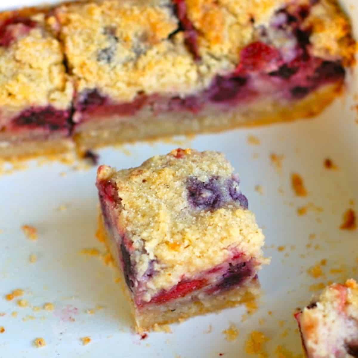 Triple berry pie bars in a baking dish.