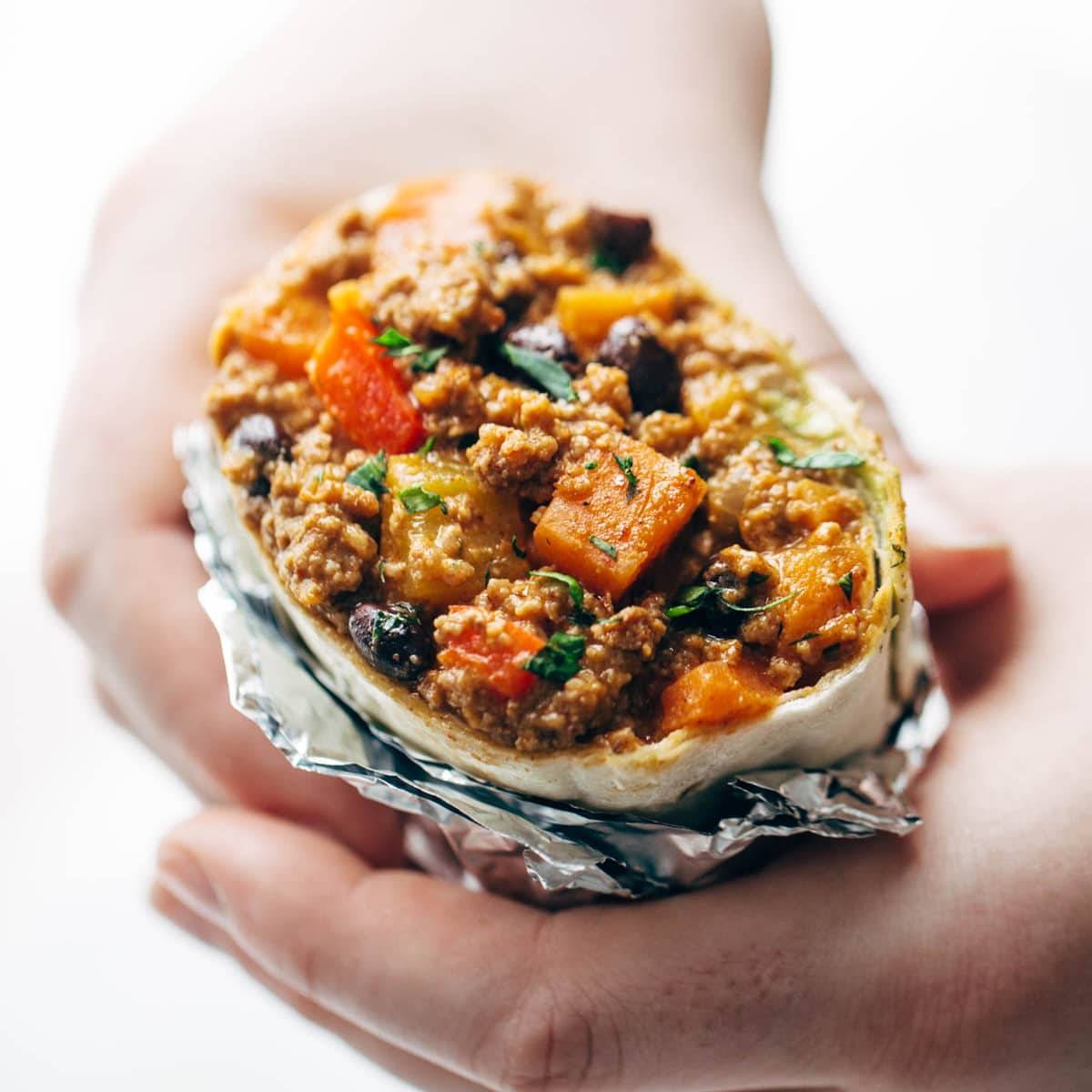 Chipotle Turkey Burrito held by hands.
