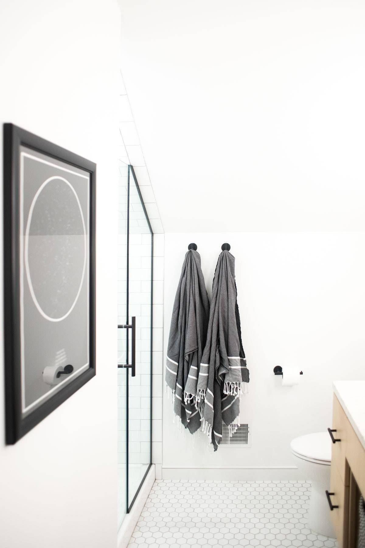 A remodelled bathroom in the attic with white and grey theme.