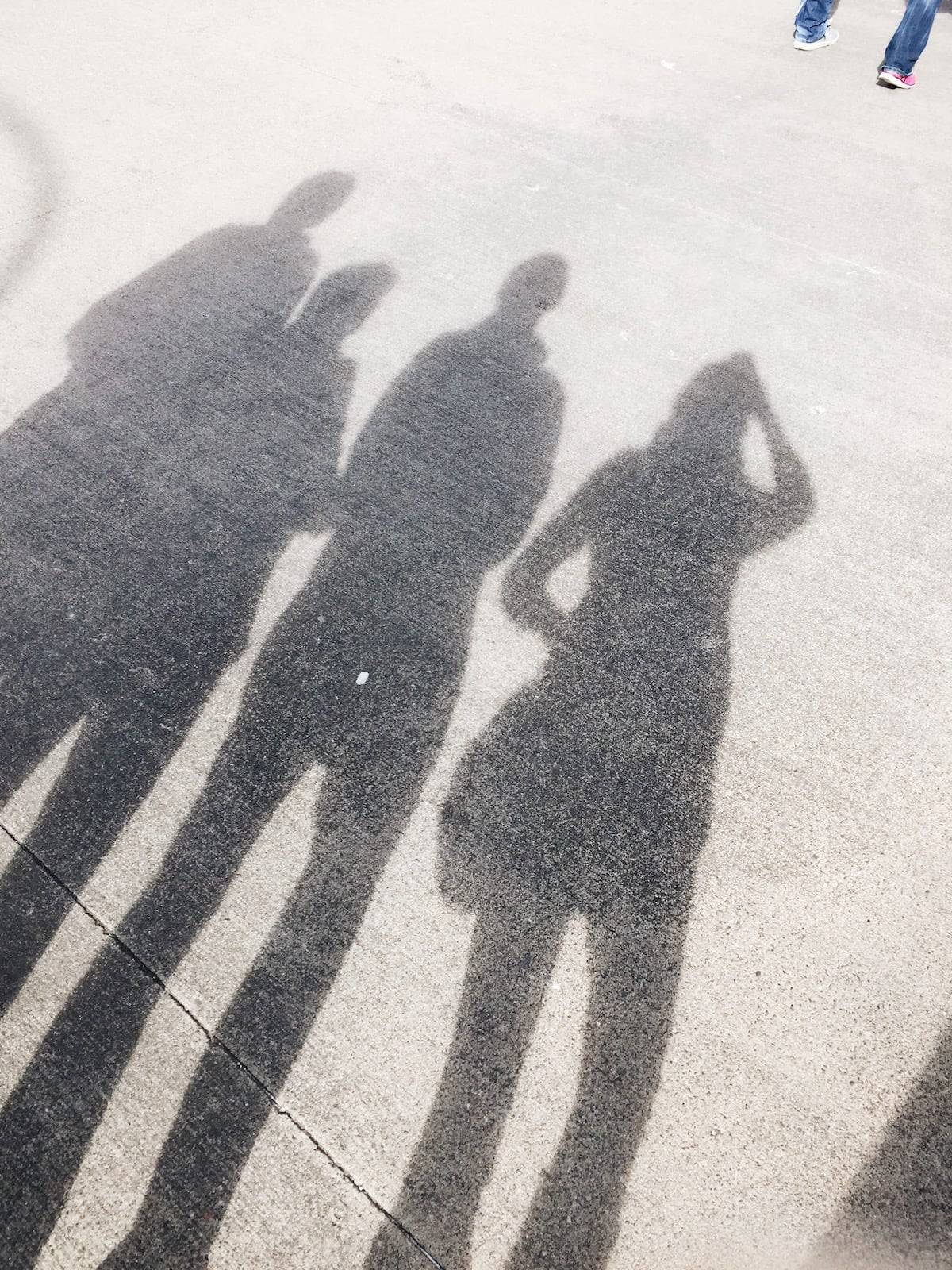 Four shadows on cement.