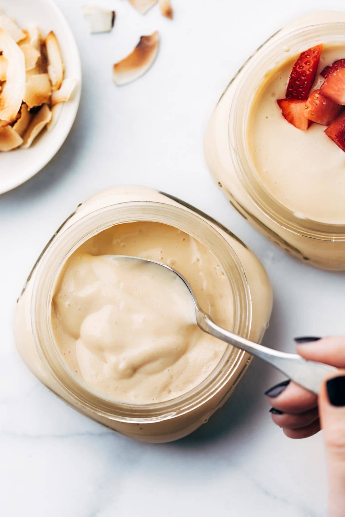 Vegan yogurt in a jar with spoon.
