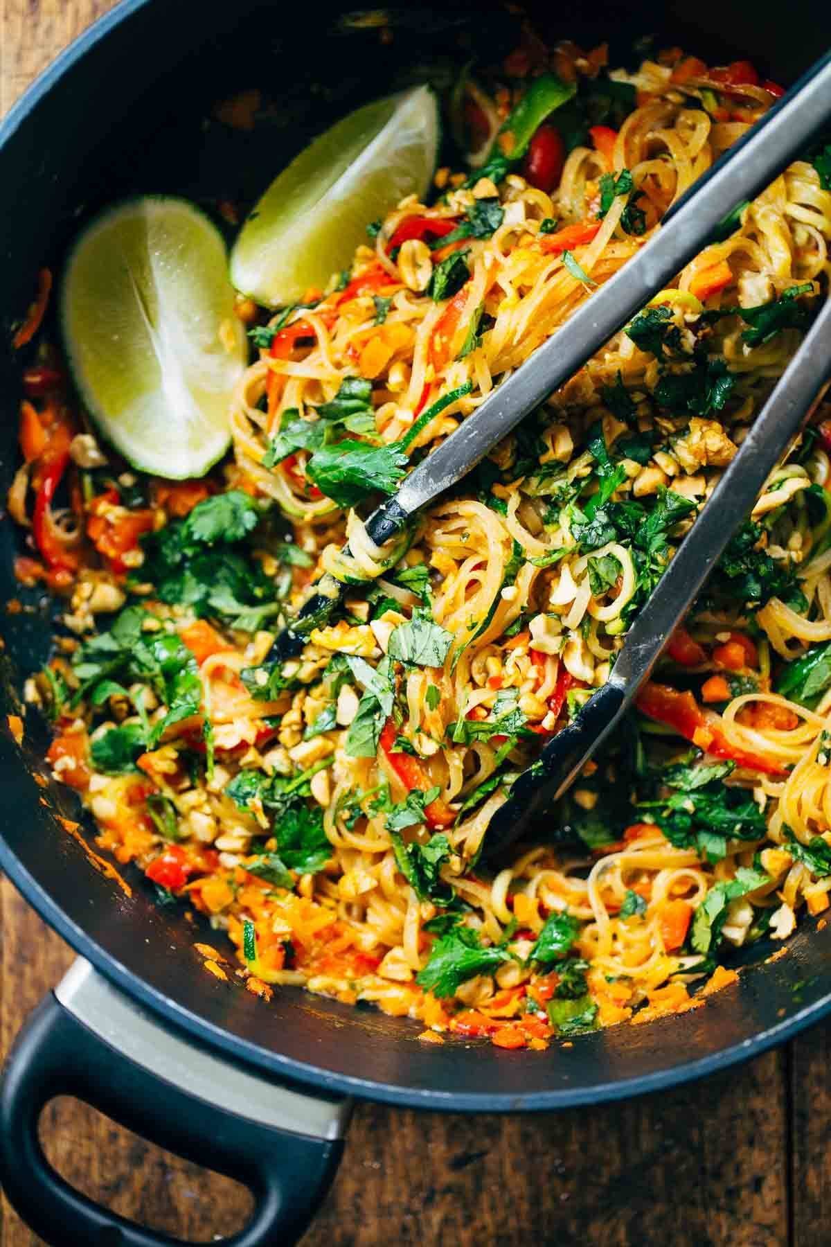 Pad Thai in Skillet with tongs