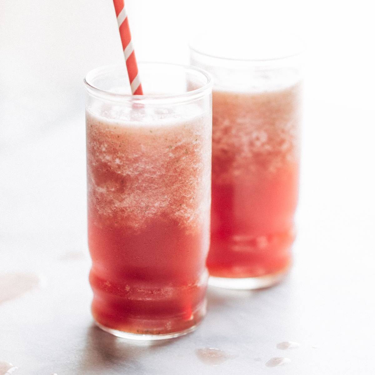 Two glasses filled with watermelon smoothies.