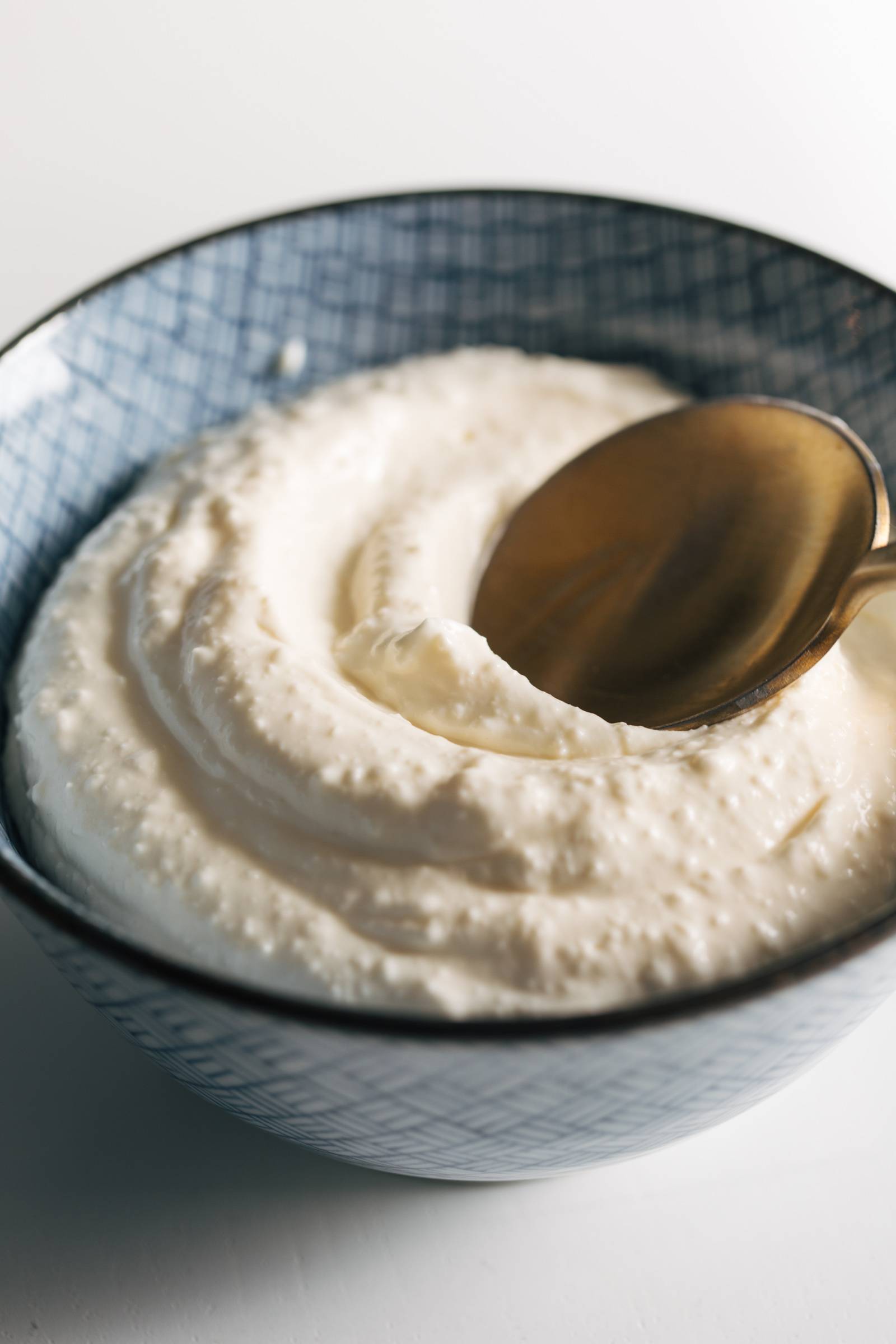 Whipped feta spread in a bowl with a spoon.