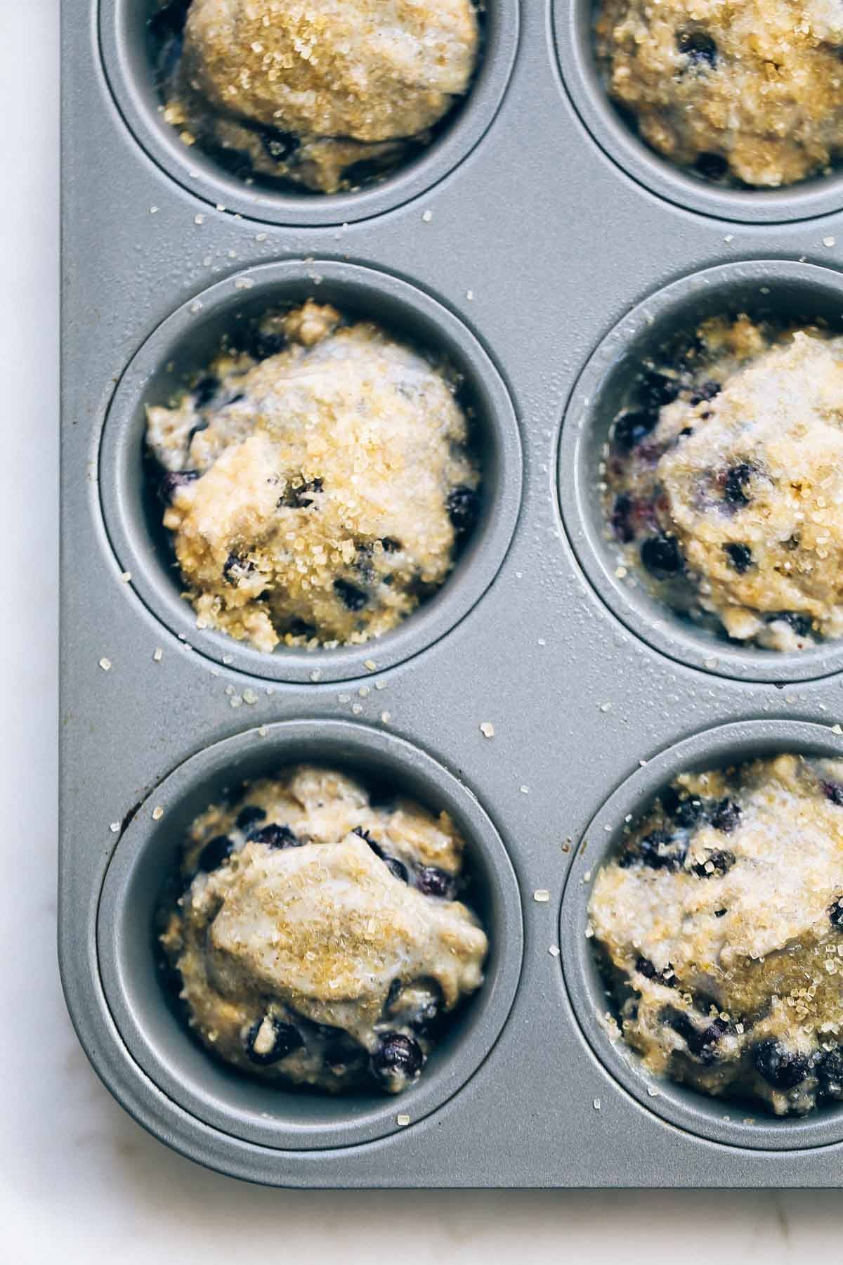 Whole Wheat Blueberry Muffins in a muffin tin.