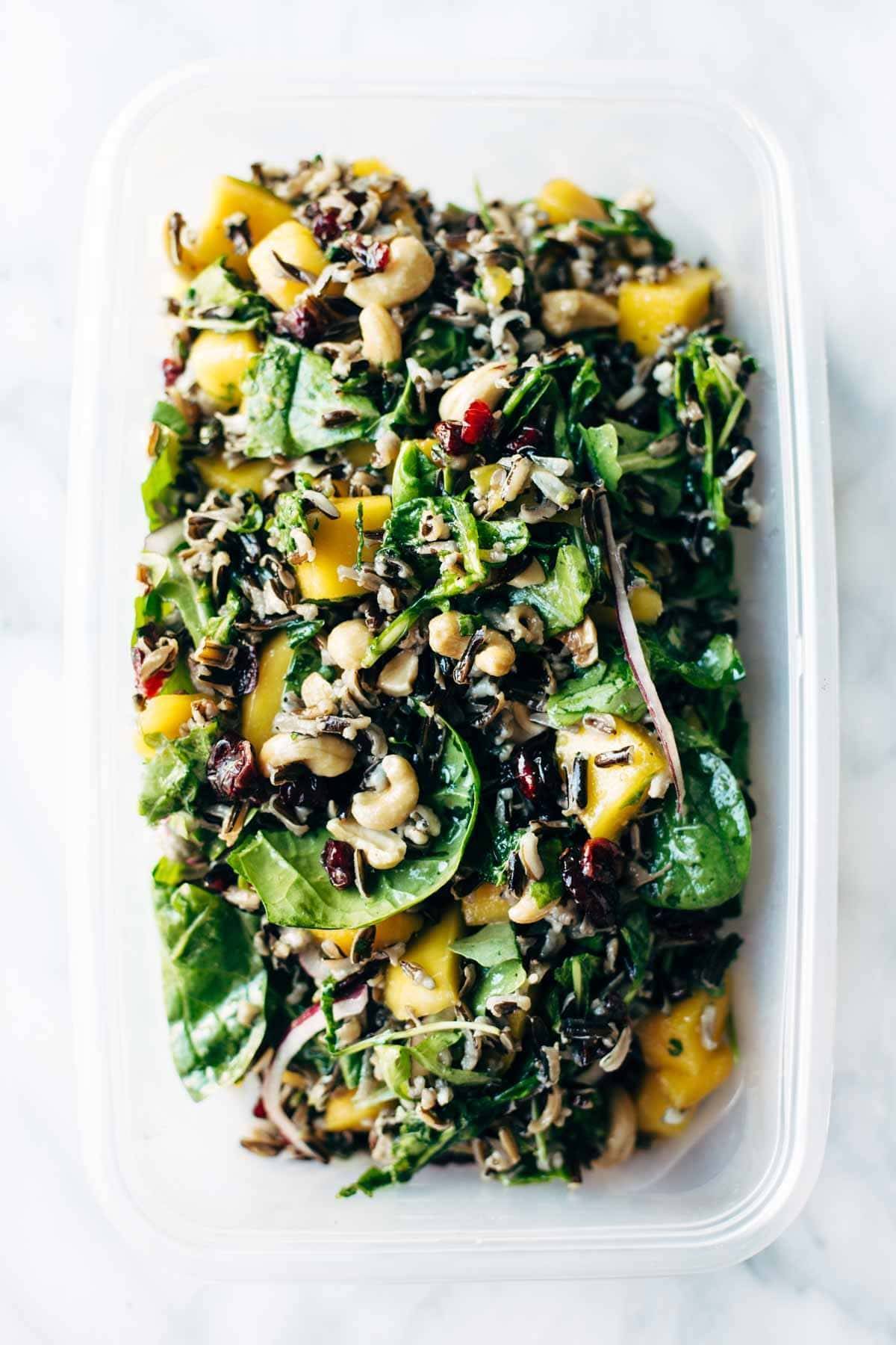 Easy Thanksgiving Salad - arugula, wild rice, cashews, dried cranberries, red onions, and a lemon dressing that shakes up easily in a jar. | pinchofyum.com