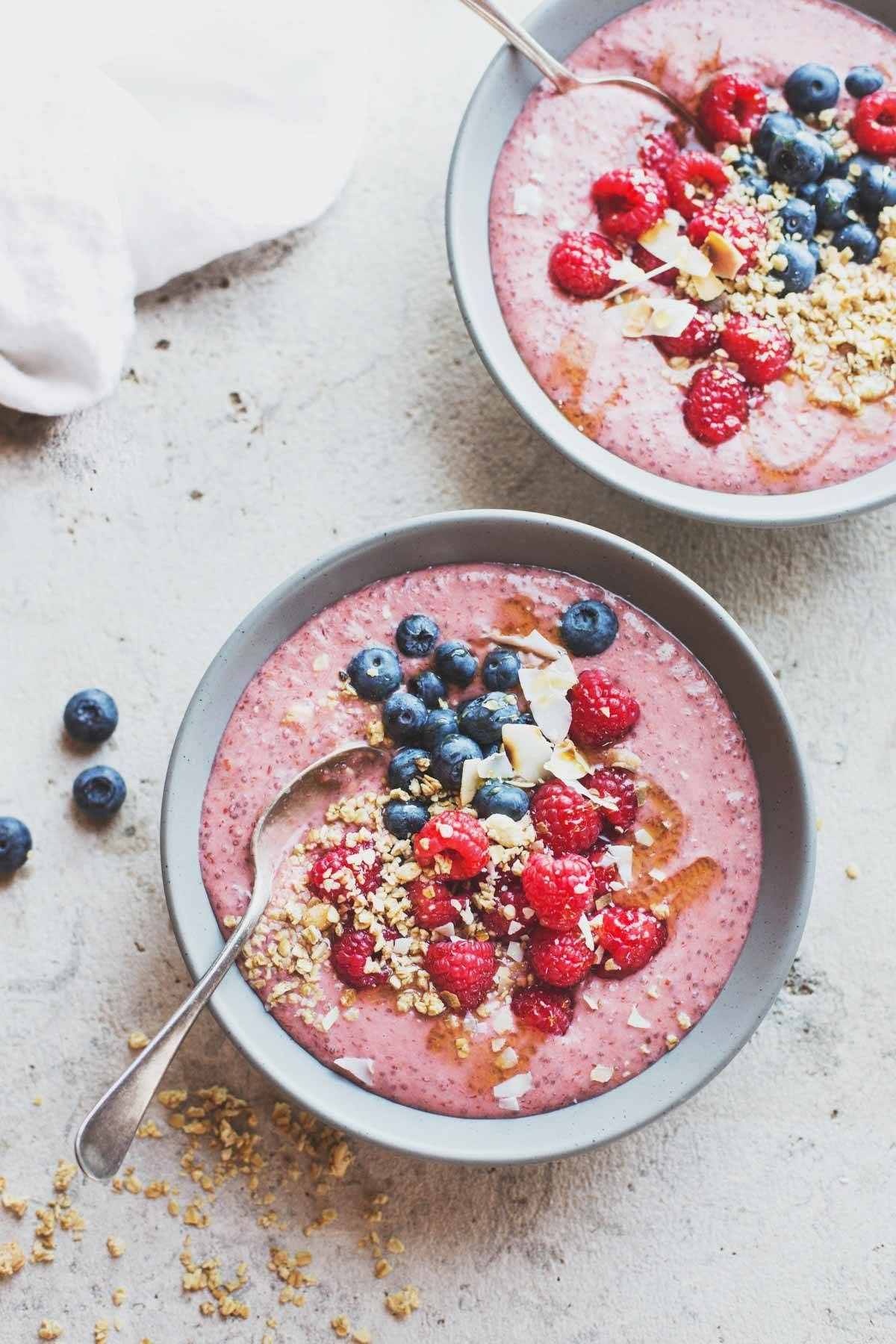 Two smoothie bowls with berries.