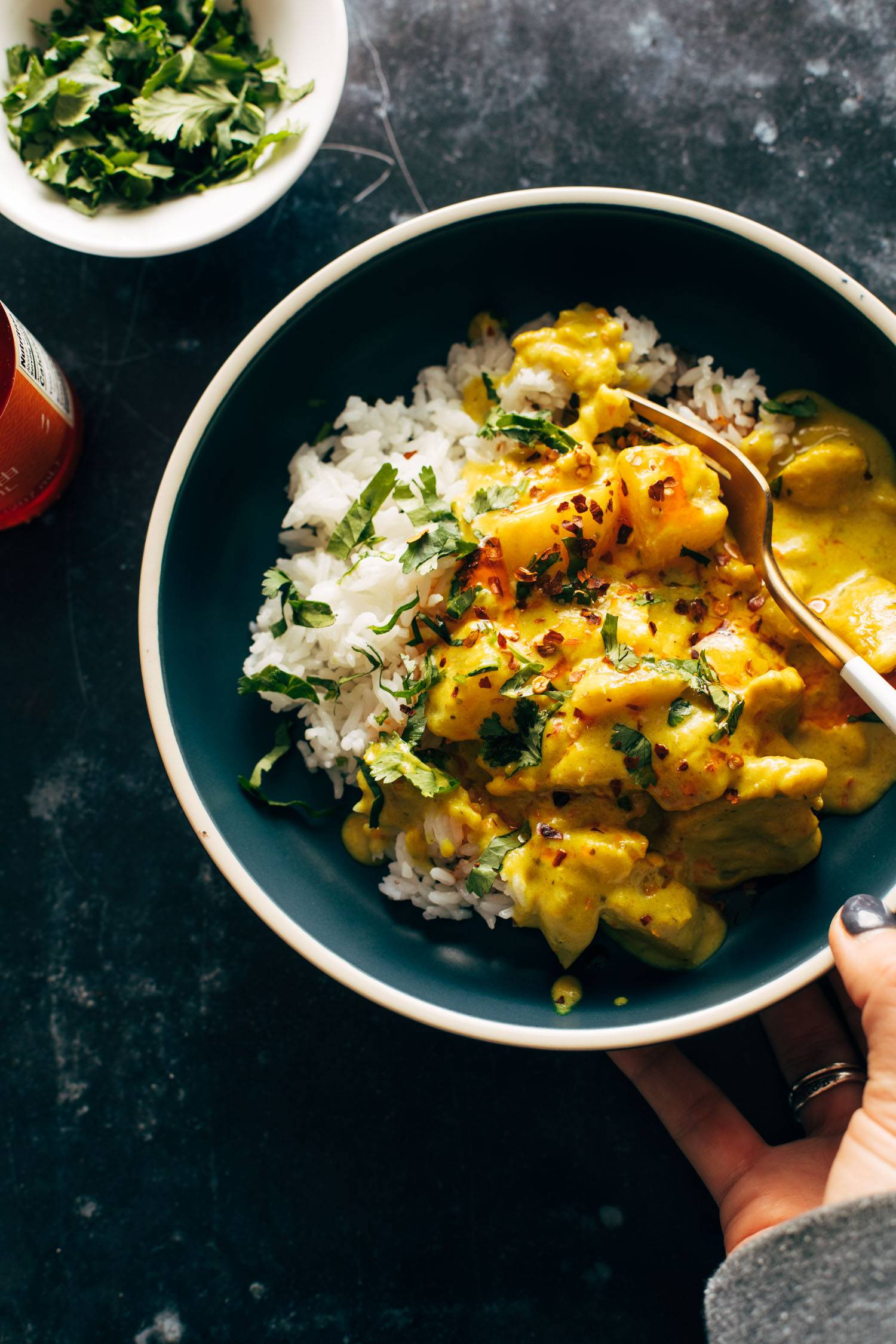 Yellow chicken curry in bowl with fork
