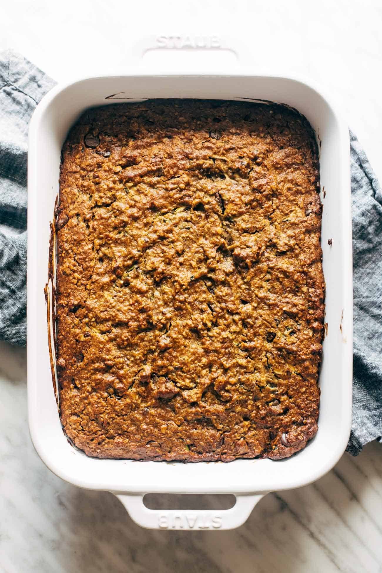 Overhead image of almond butter chocolate chip zucchini bars in a pan. 