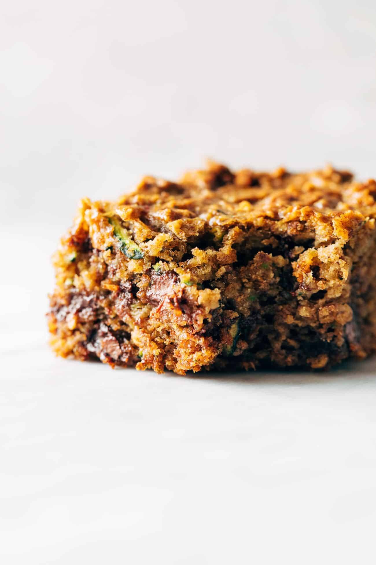 Almond butter chocolate chip zucchini bar with a bite taken out of it. 