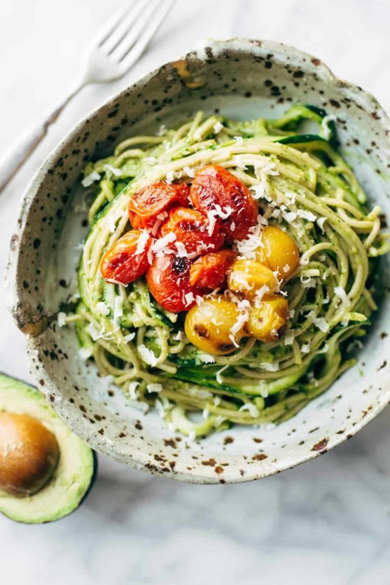 Zucchini spaghetti with tomato topping in a bowl.