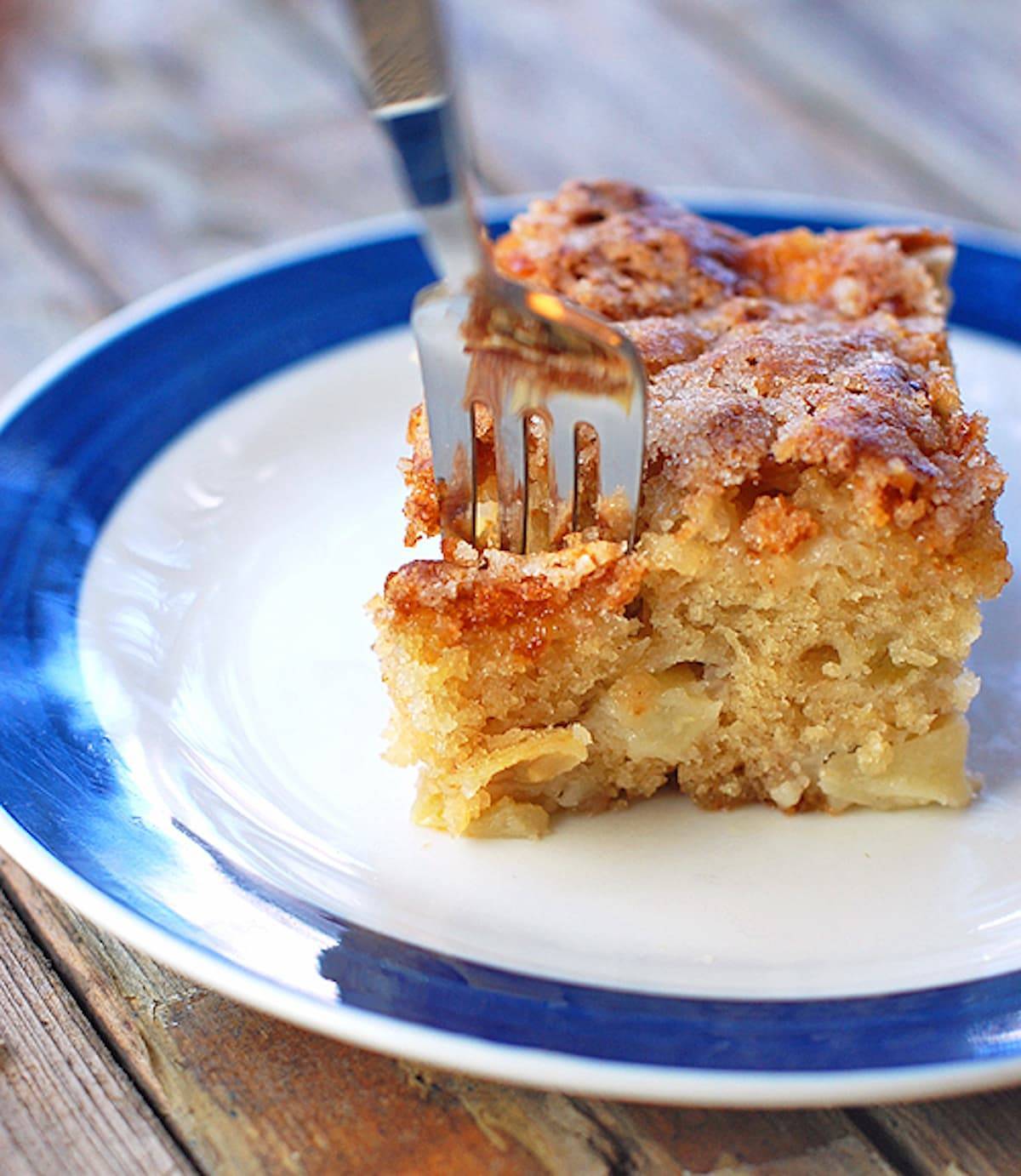 Cinnamon Sugar Apple Cake on a blue and white plate with a fork.
