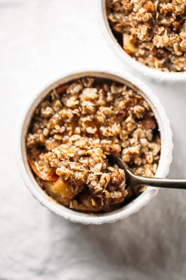 Apple Crisp in a small dish with a spoon.