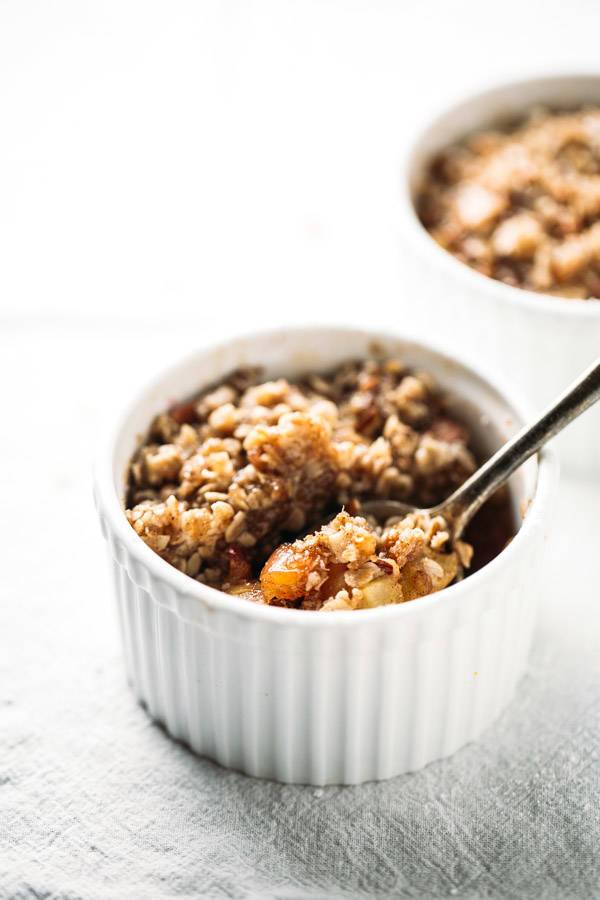 Apple crisp in a white dish.