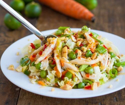 Asian chicken salad on a plate with a fork.