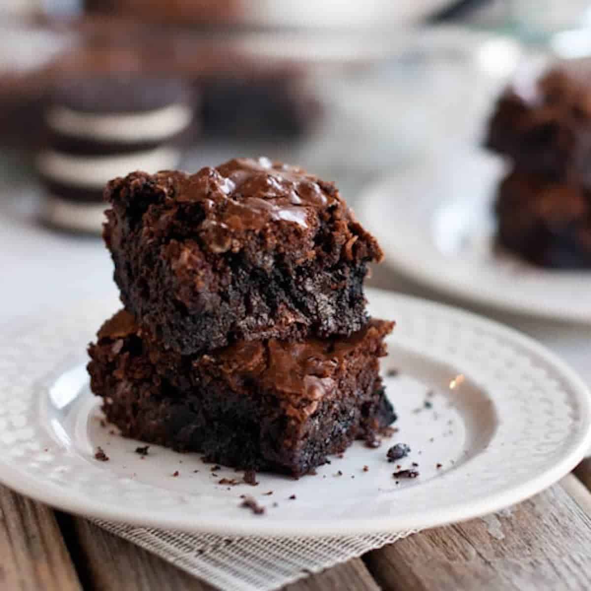 Two brownies on a white plate.
