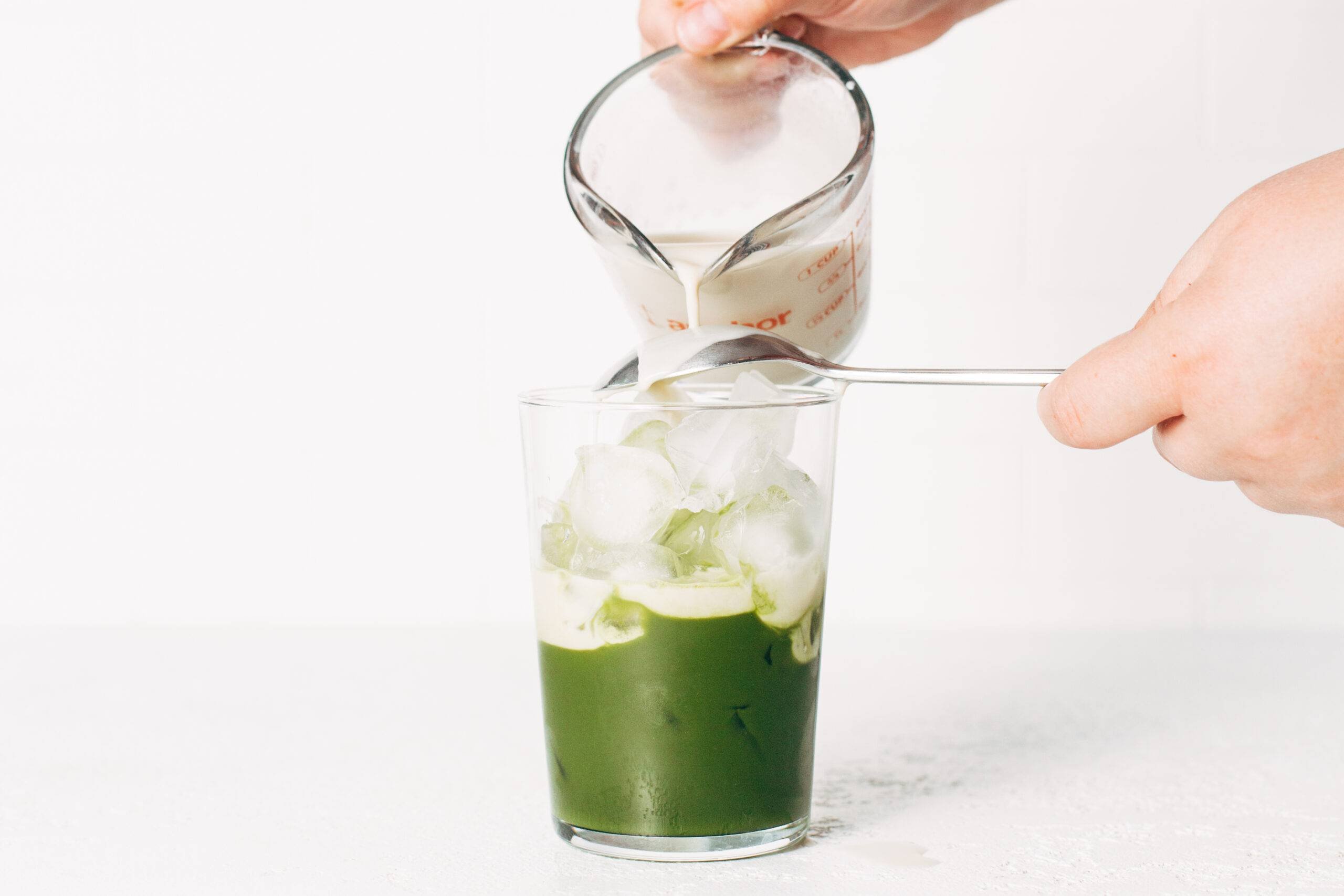 Oat milk and matcha in a glass with ice