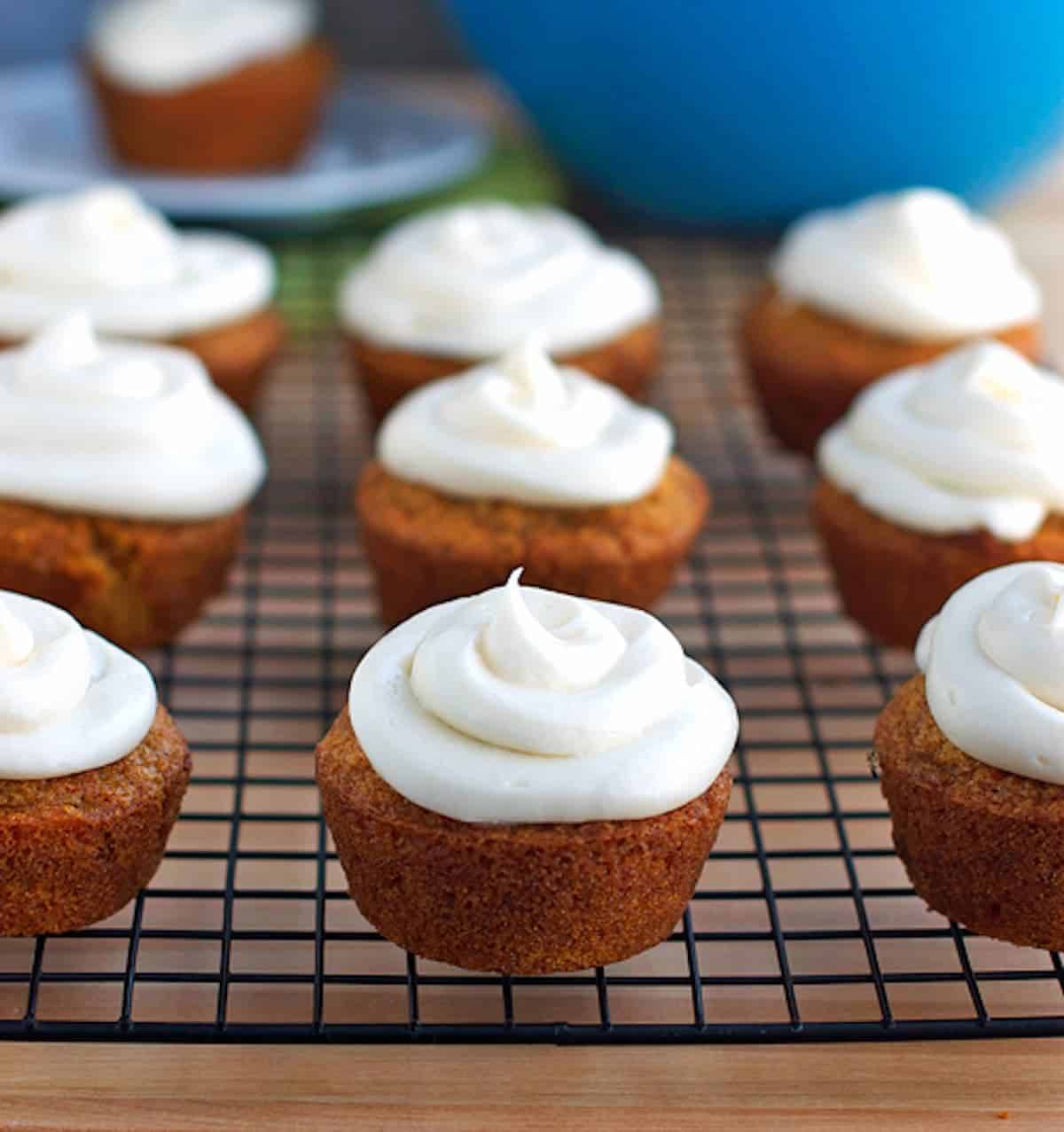 These carrot cake cupcakes are made from a small town blue ribbon recipe. Sweet, moist, dense, and perfect topped with cream cheese frosting. | pinchofyum.com
